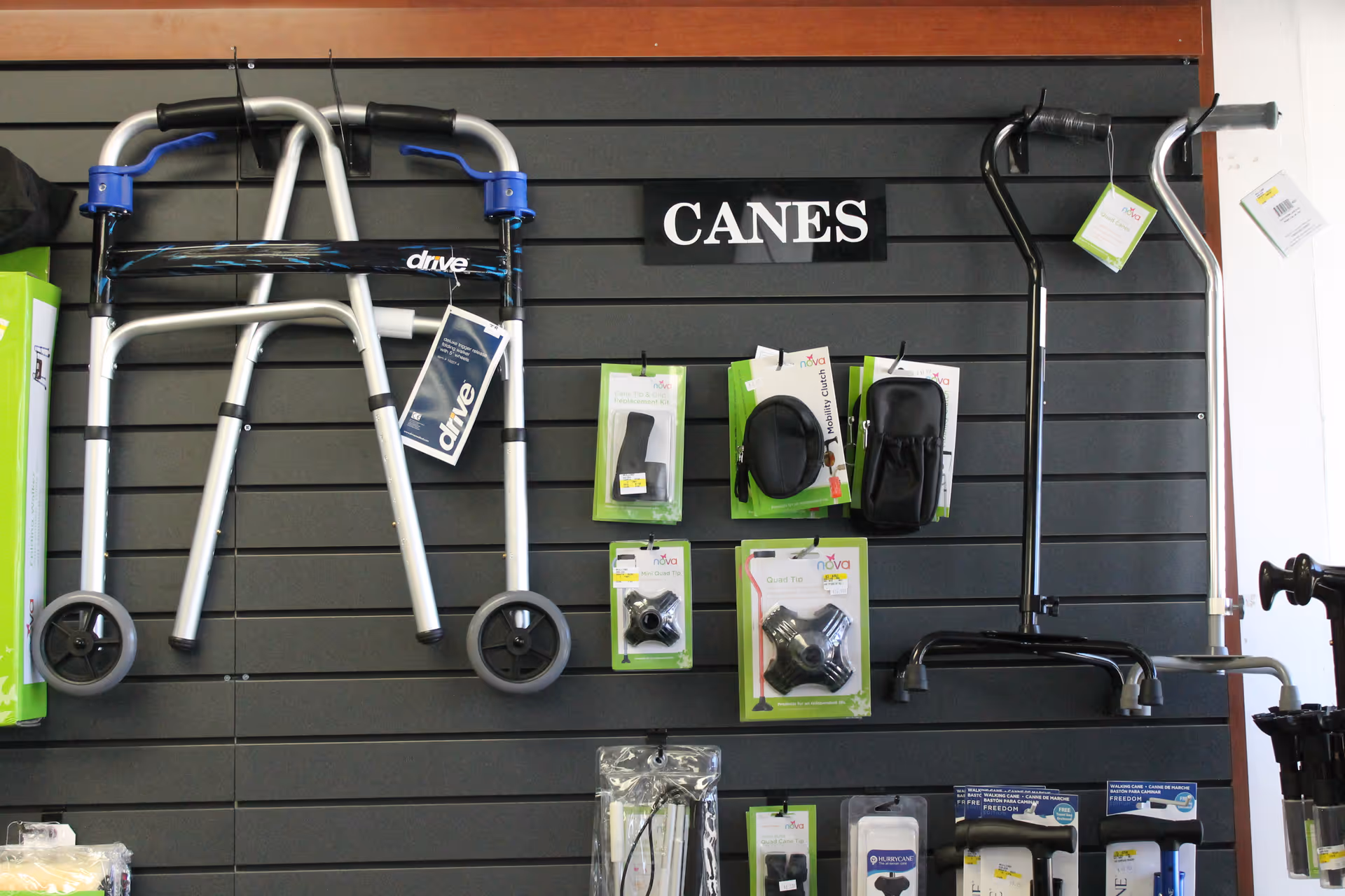 Wall-mounted display of canes and mobility aids labeled CANES in a facility showroom