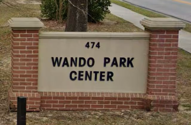 A brick-framed sign reading '474 Wando Park Center' at the front of a property.