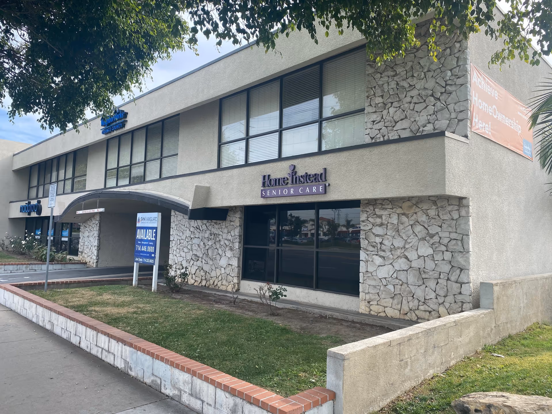 Exterior view of a Home Instead Senior Care storefront with stone accents