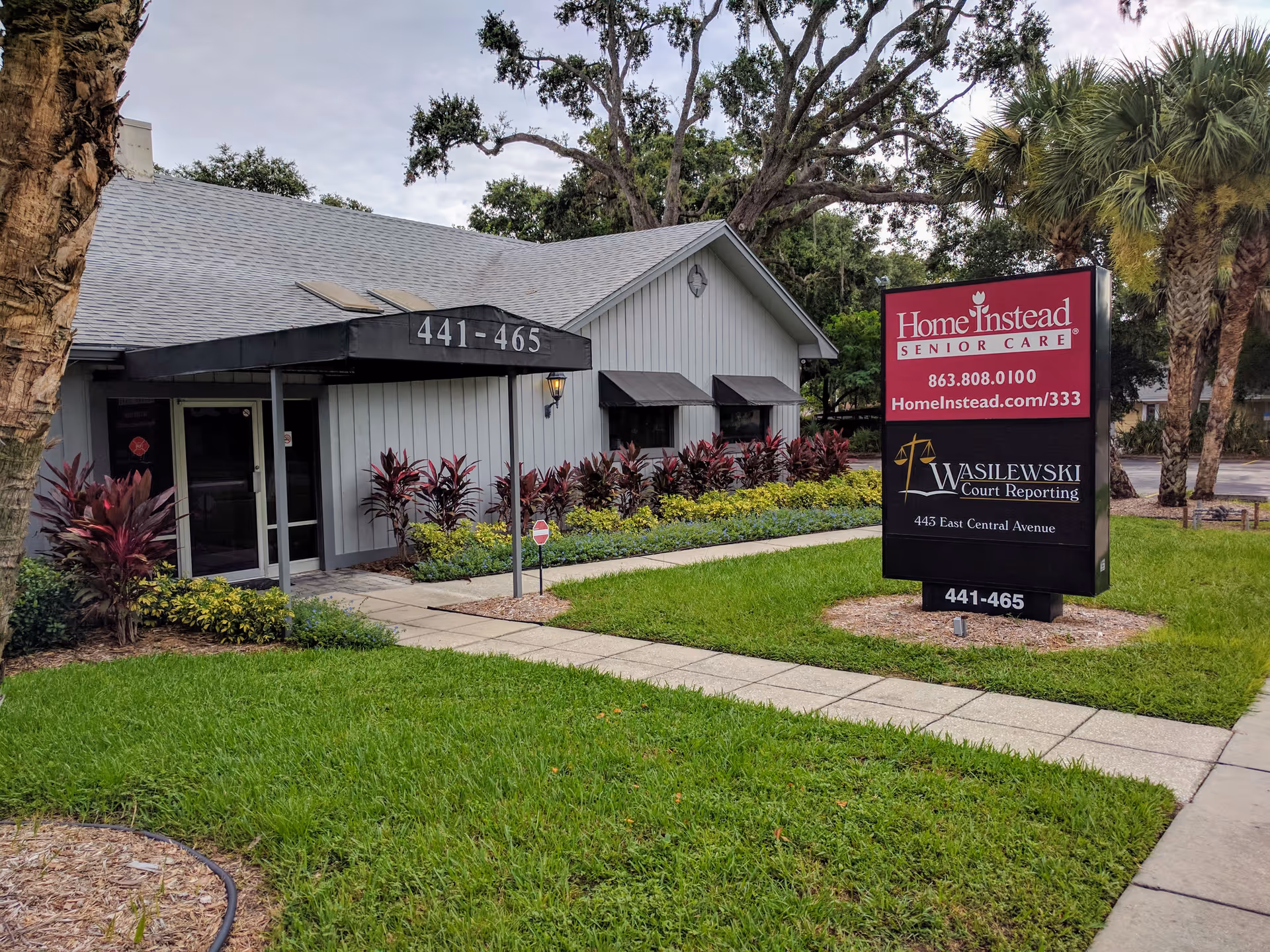 Front view of a Home Instead Senior Care building with a large sign and landscaped walkway.