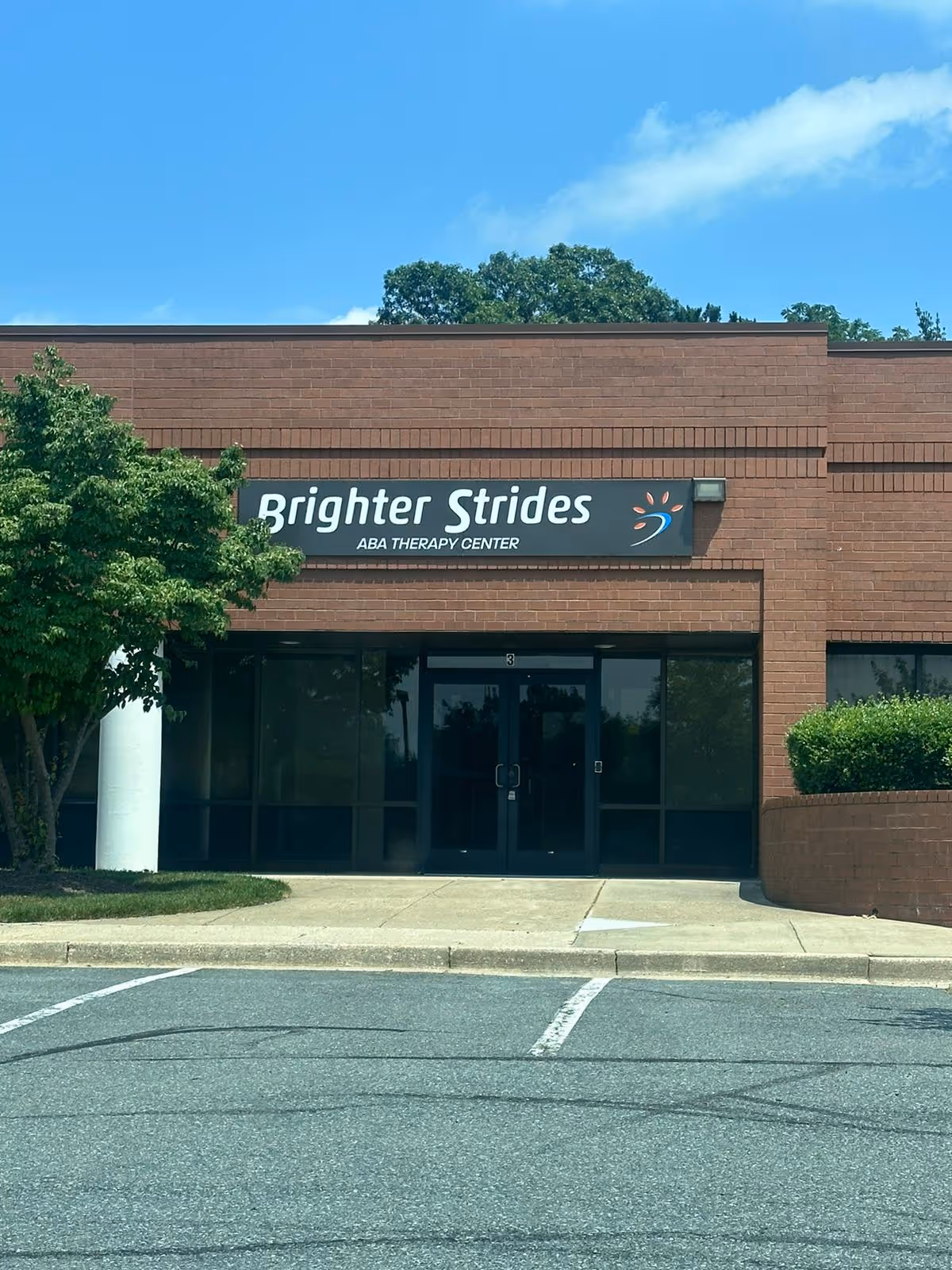 Brick building facade with Brighter Strides ABA Therapy Center sign at entrance.