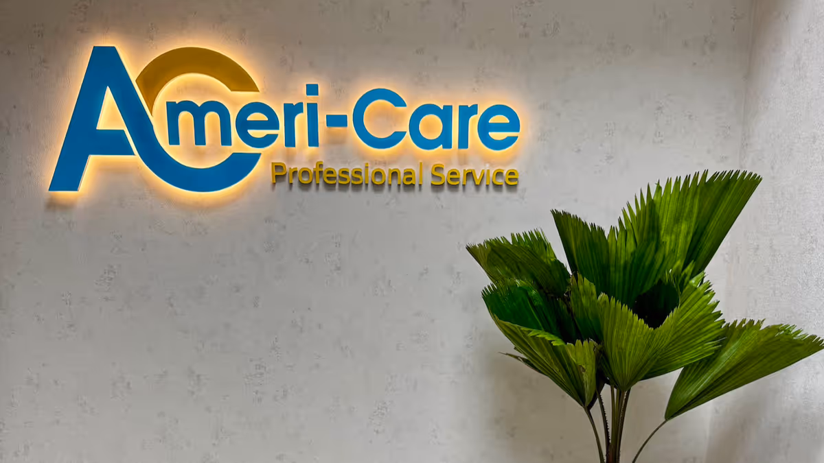 Interior wall with Ameri-Care Professional Service logo and a large green plant.