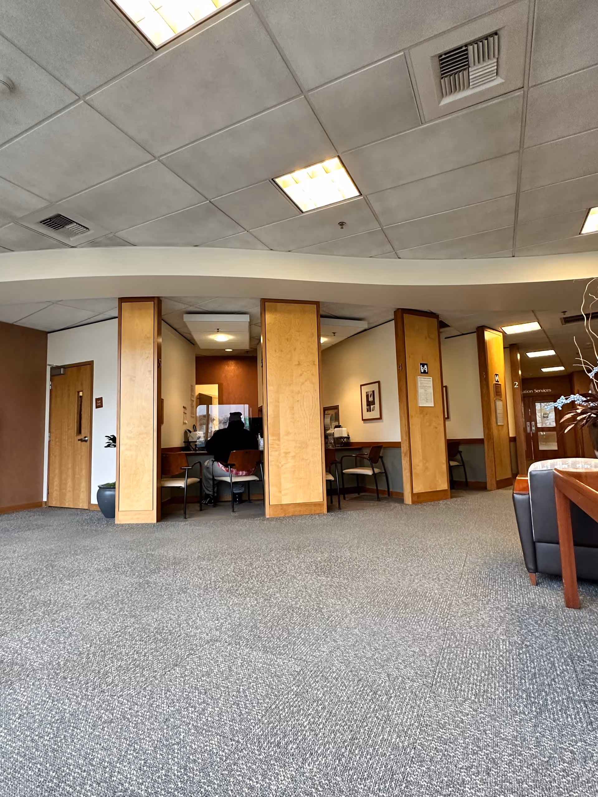 A St. Francis Hospital lobby with wooden partitions and seating areas.