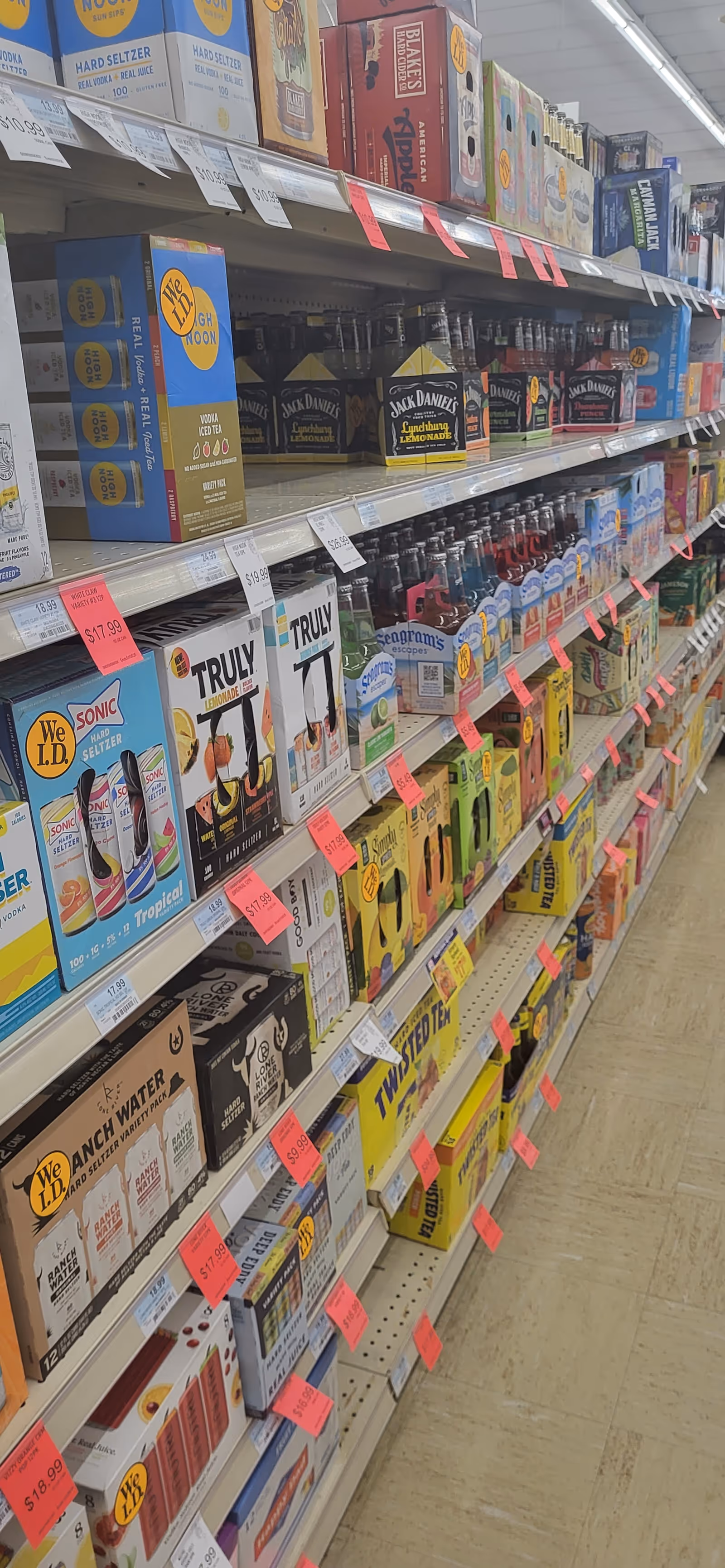 Aisles stocked with boxed beverages and assorted products on shelves inside Discount Drug Mart.