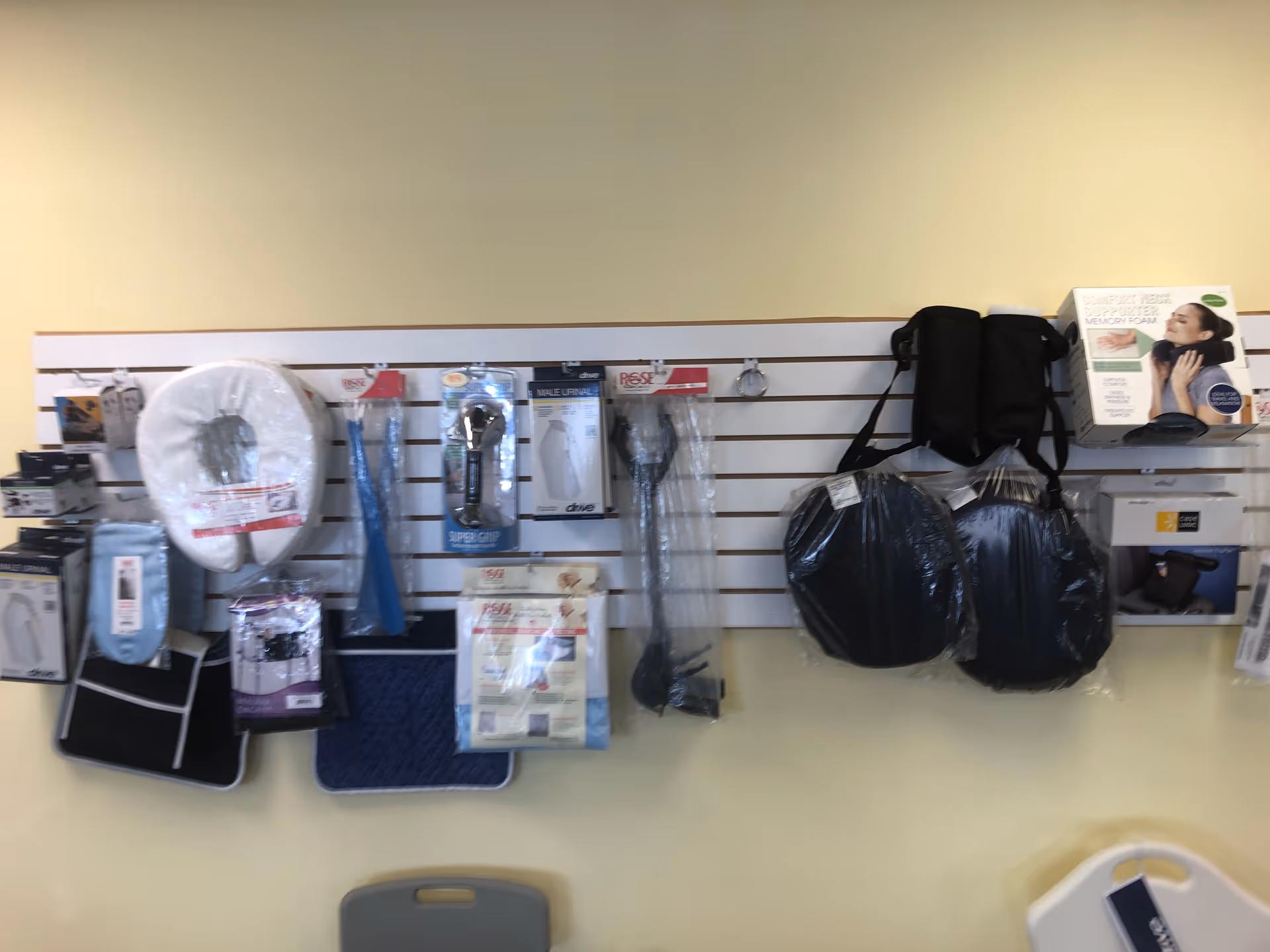 Wall display of medical supplies and accessories in a light colored interior room.