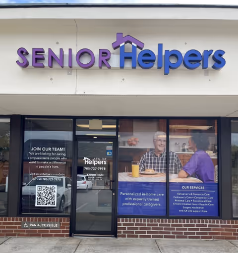 Front facade of Senior Helpers facility with purple and blue sign.
