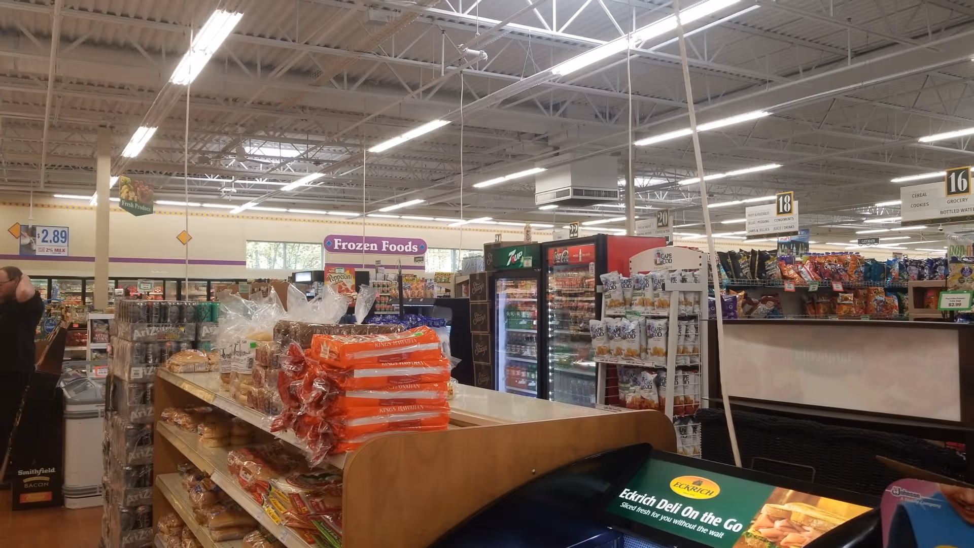 Inside a Discount Drug Mart store with aisles, refrigerated sections, and checkout.