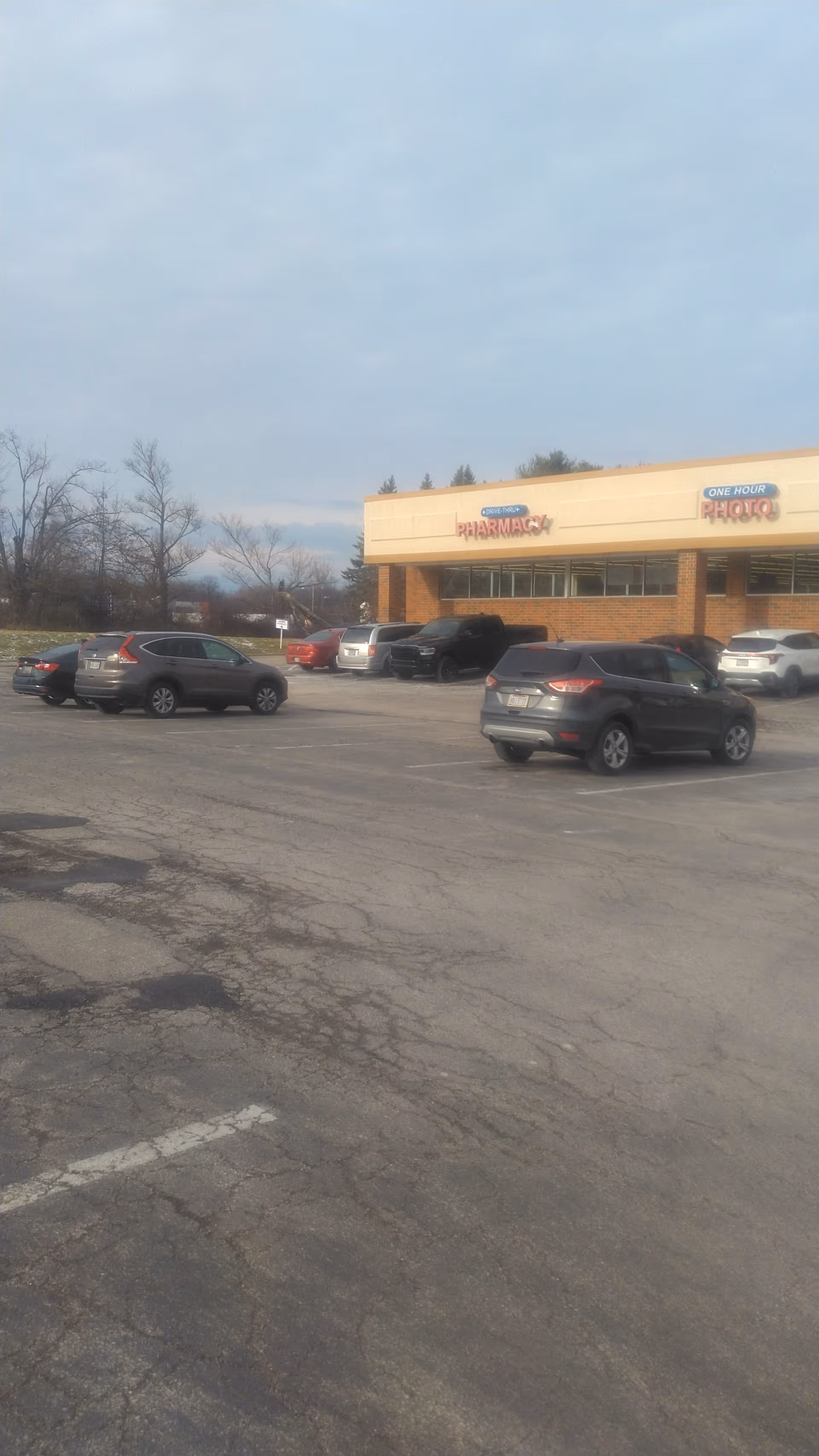 Parking lot and Discount Drug Mart storefront with visible pharmacy sign.
