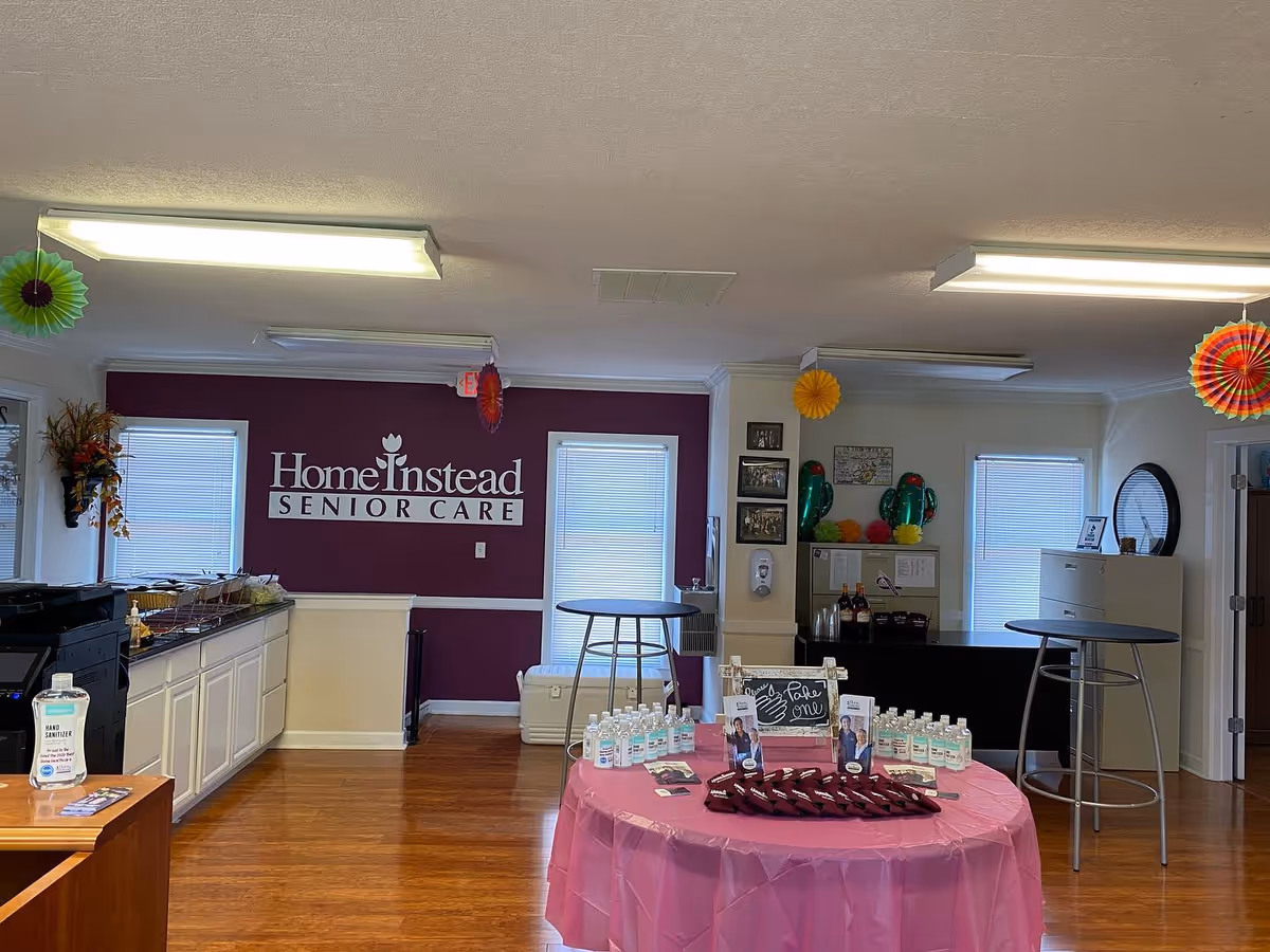 Interior view of Home Instead Senior Care lobby with pink table and decorations.
