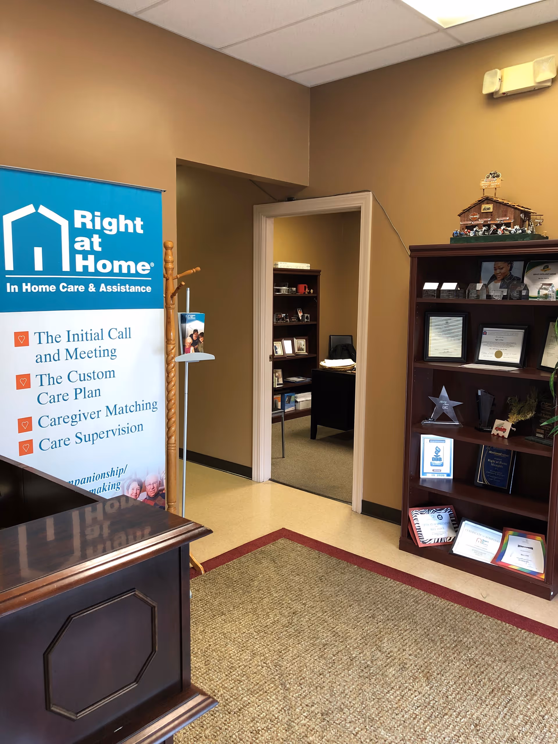 Lobby area with a Right at Home banner, reception desk, and bookshelf.