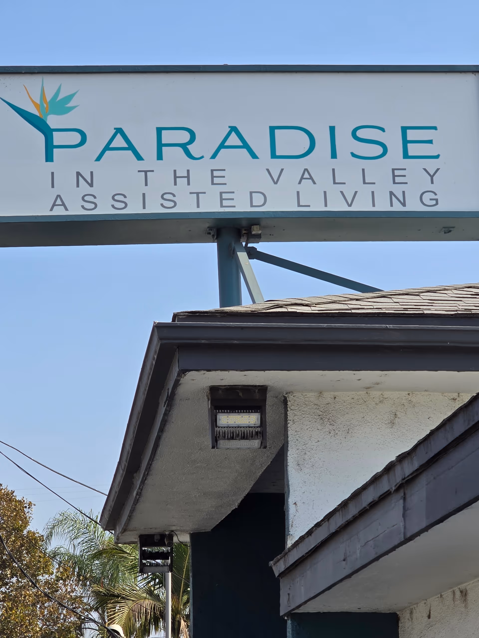 Outdoor view of the Paradise in the Valley Assisted Living sign above the building entrance.