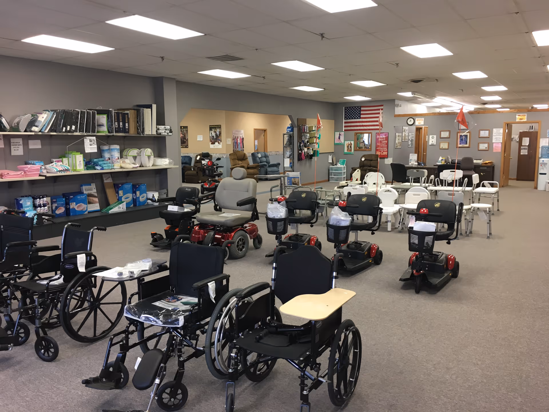 Spacious indoor showroom displaying wheelchairs, walkers, and mobility scooters.