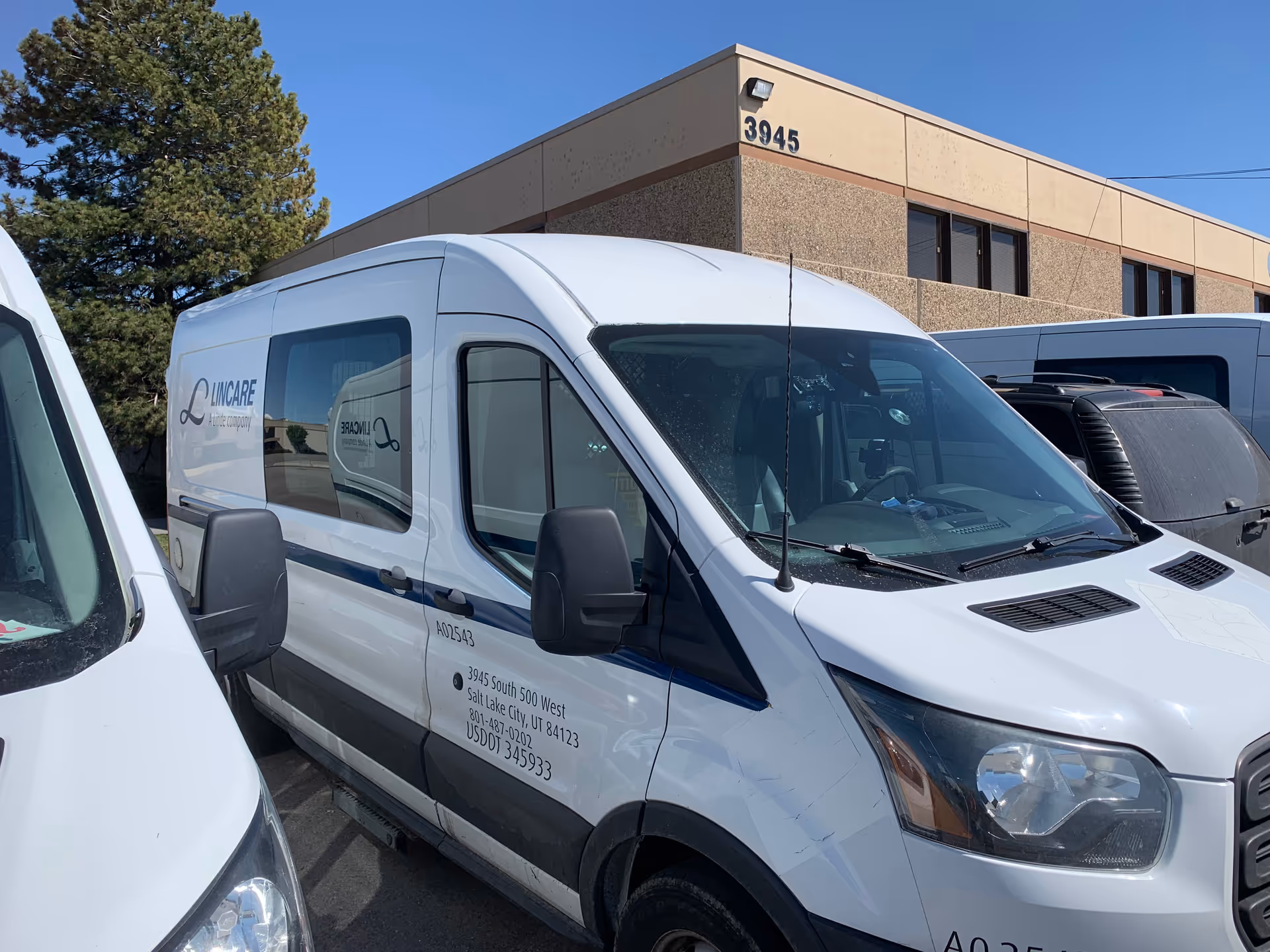 White LINCARE vans parked in front of a beige building labeled 3945.