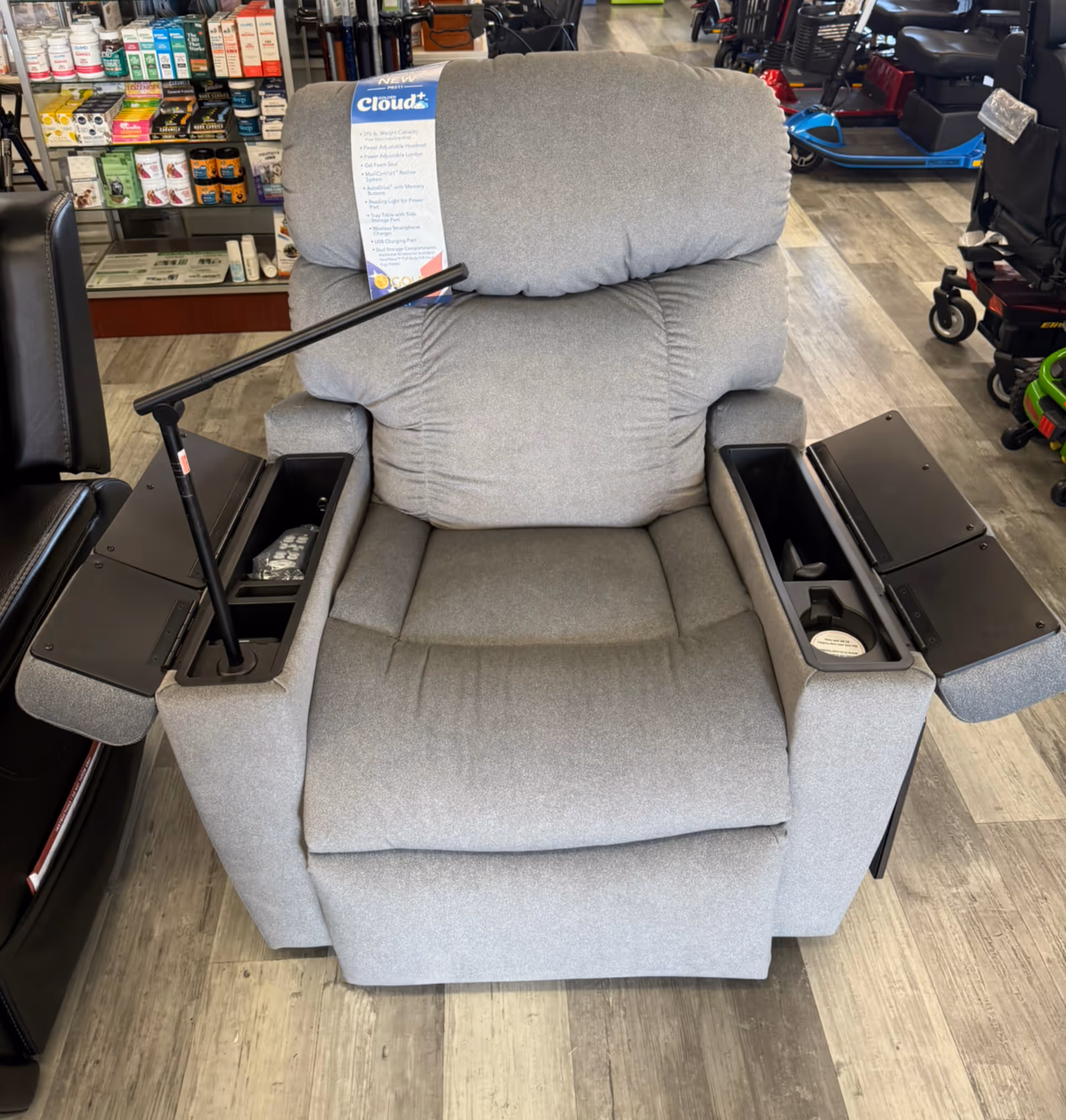 Gray reclining lift chair on display inside a medical supply showroom.
