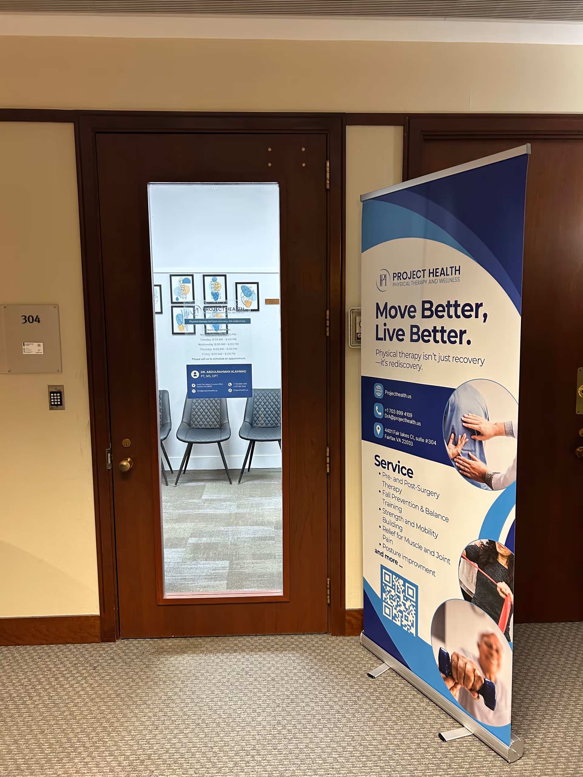 Wood doorway with glass panel leads to a waiting area; a Project Health banner stands nearby.