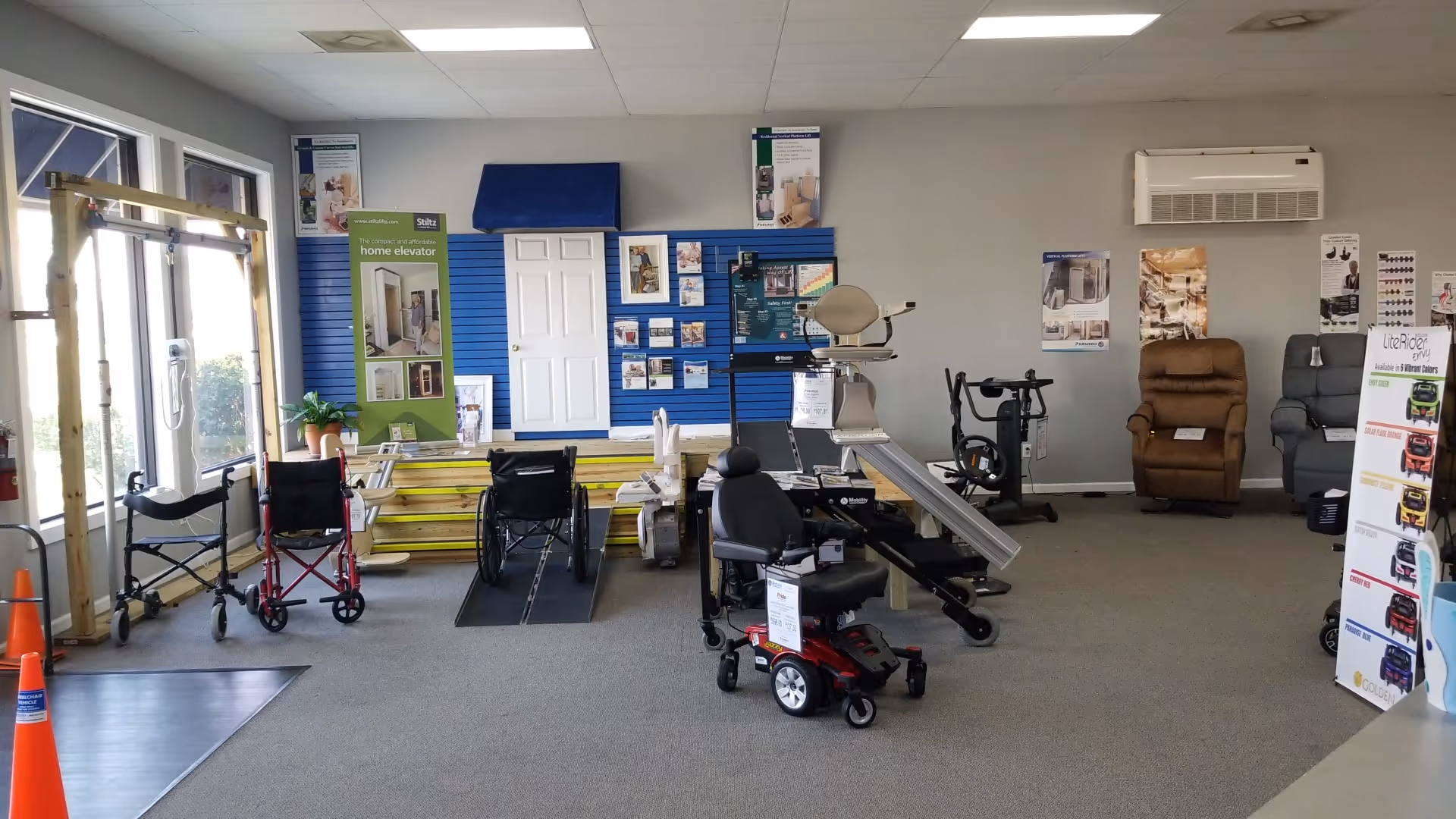 Interior showroom displaying mobility equipment such as ramps, chairs, and wheelchairs.