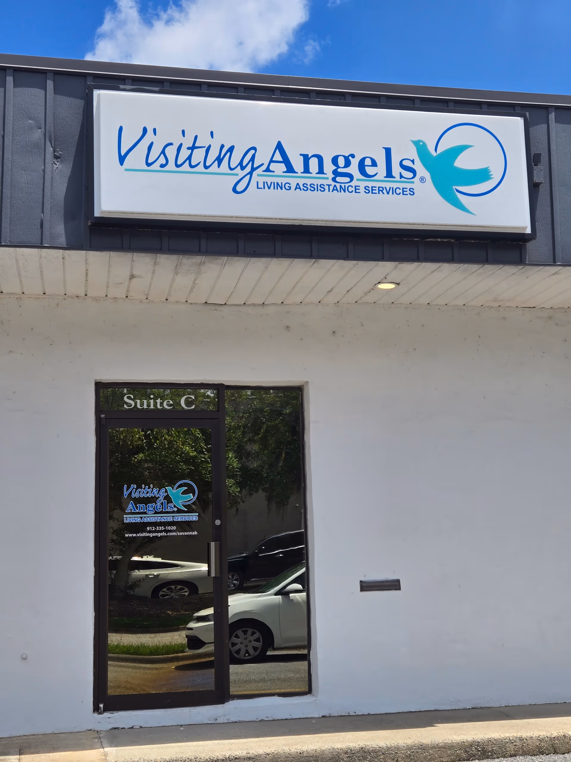 Exterior view of Visiting Angels storefront sign and glass door.