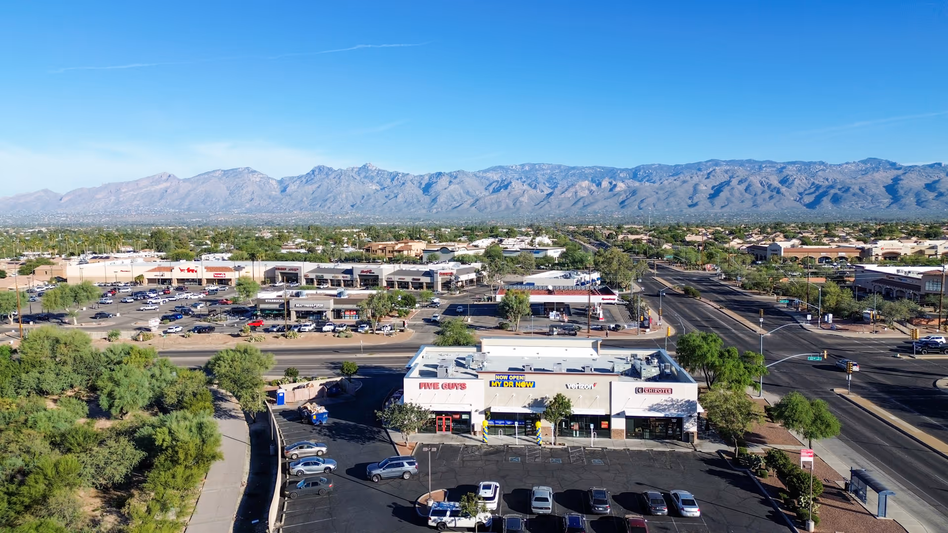 Aerial view of a shopping plaza featuring MY DR NOW clinic and surrounding parking.