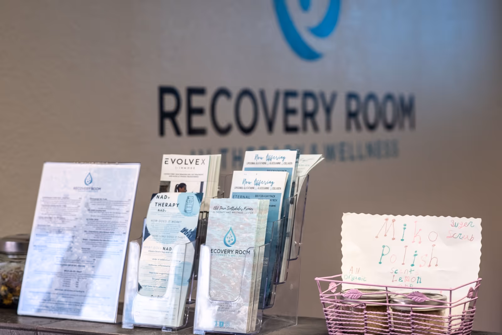 Brochure rack with pamphlets and a Recovery Room sign inside a senior wellness facility.