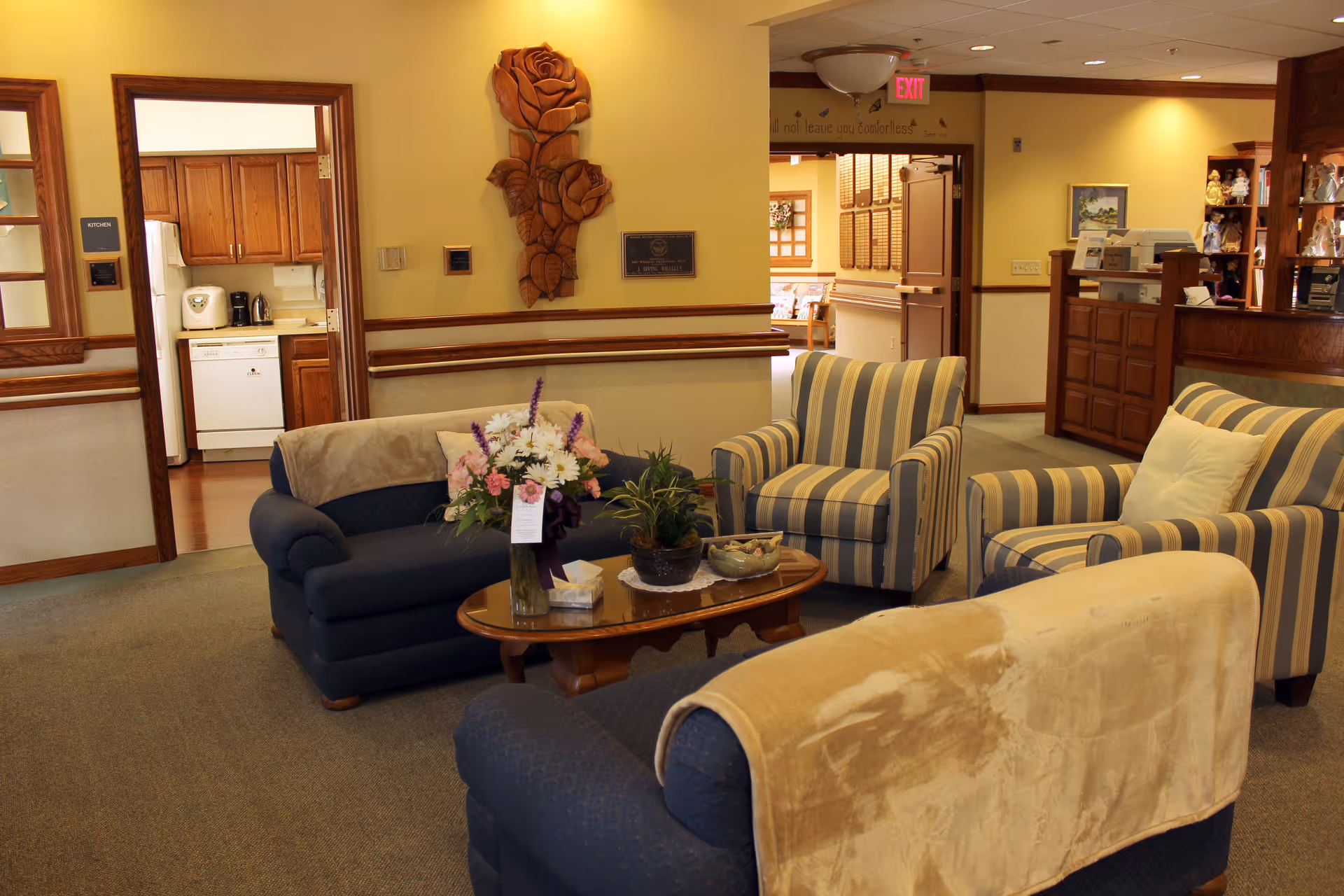 Windber Hospice lobby lounge with striped chairs, couches, and a coffee table arrangement.