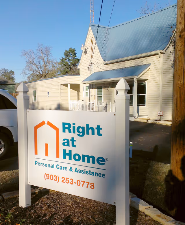 Exterior view of Right at Home facility with a large sign and entrance.