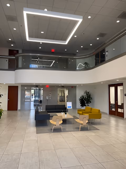 BAYADA Home Health lobby interior featuring modern seating and a curved second-floor balcony