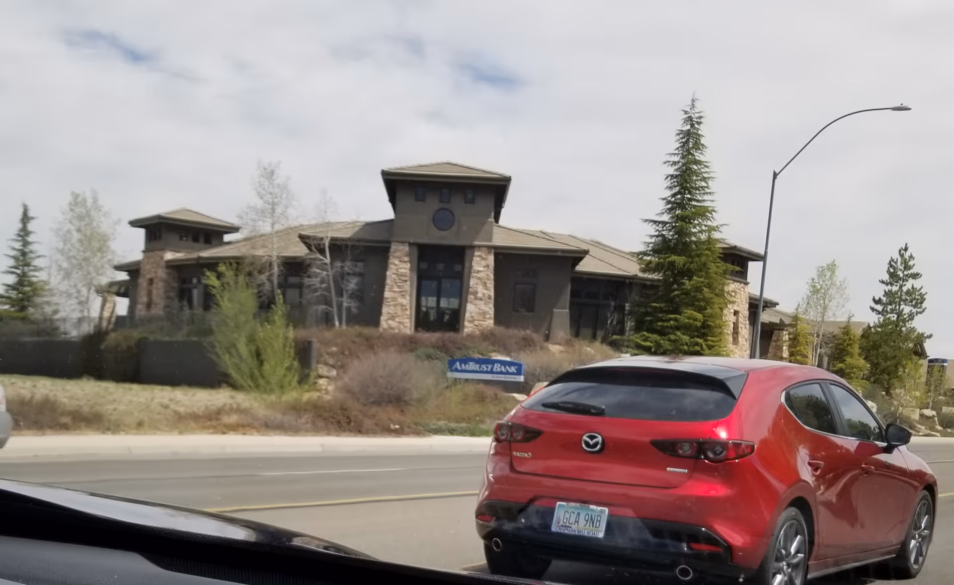 Exterior view of a BAYADA Home Health facility with a red car on the road.