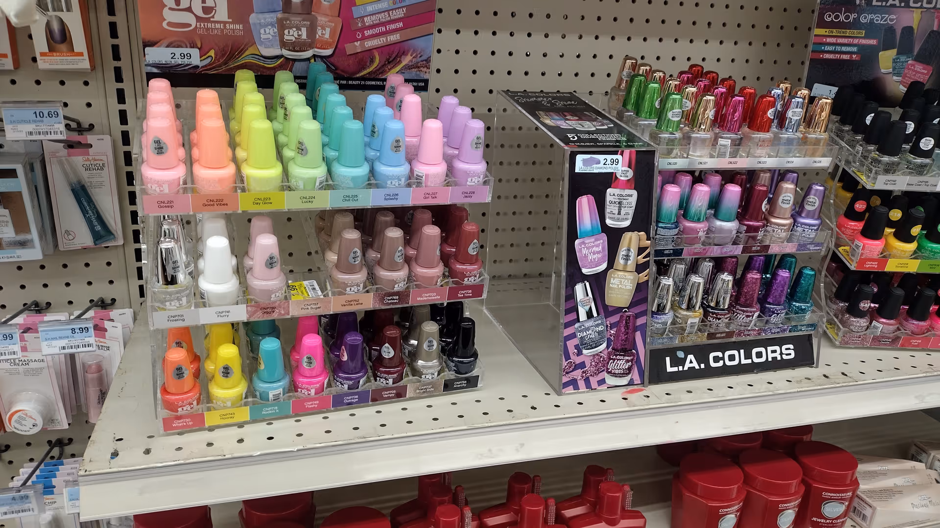 Nail polish display shelves with colorful bottles inside Discount Drug Mart.
