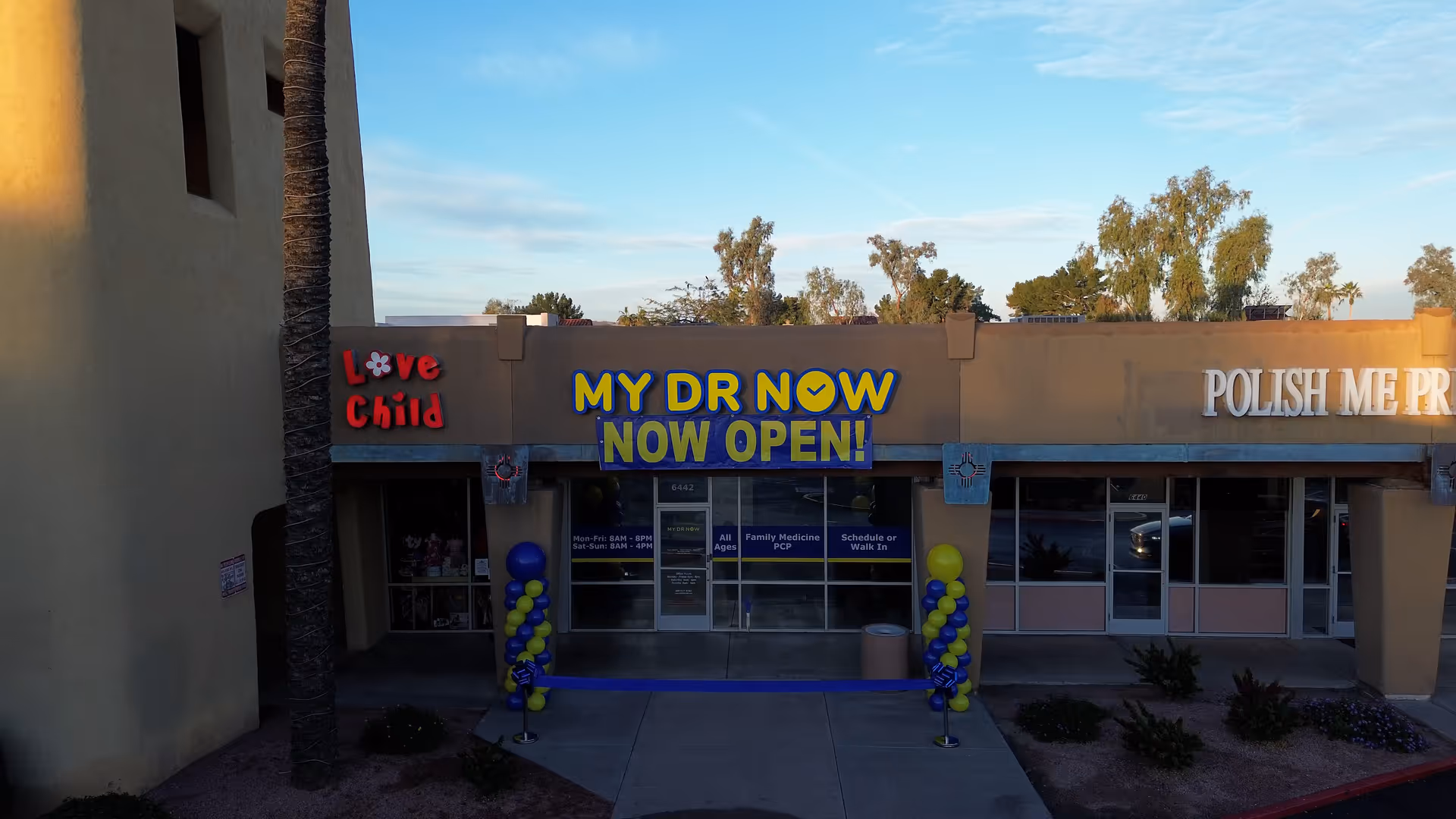 Exterior of a clinic storefront with MY DR NOW sign and balloons at entrance.
