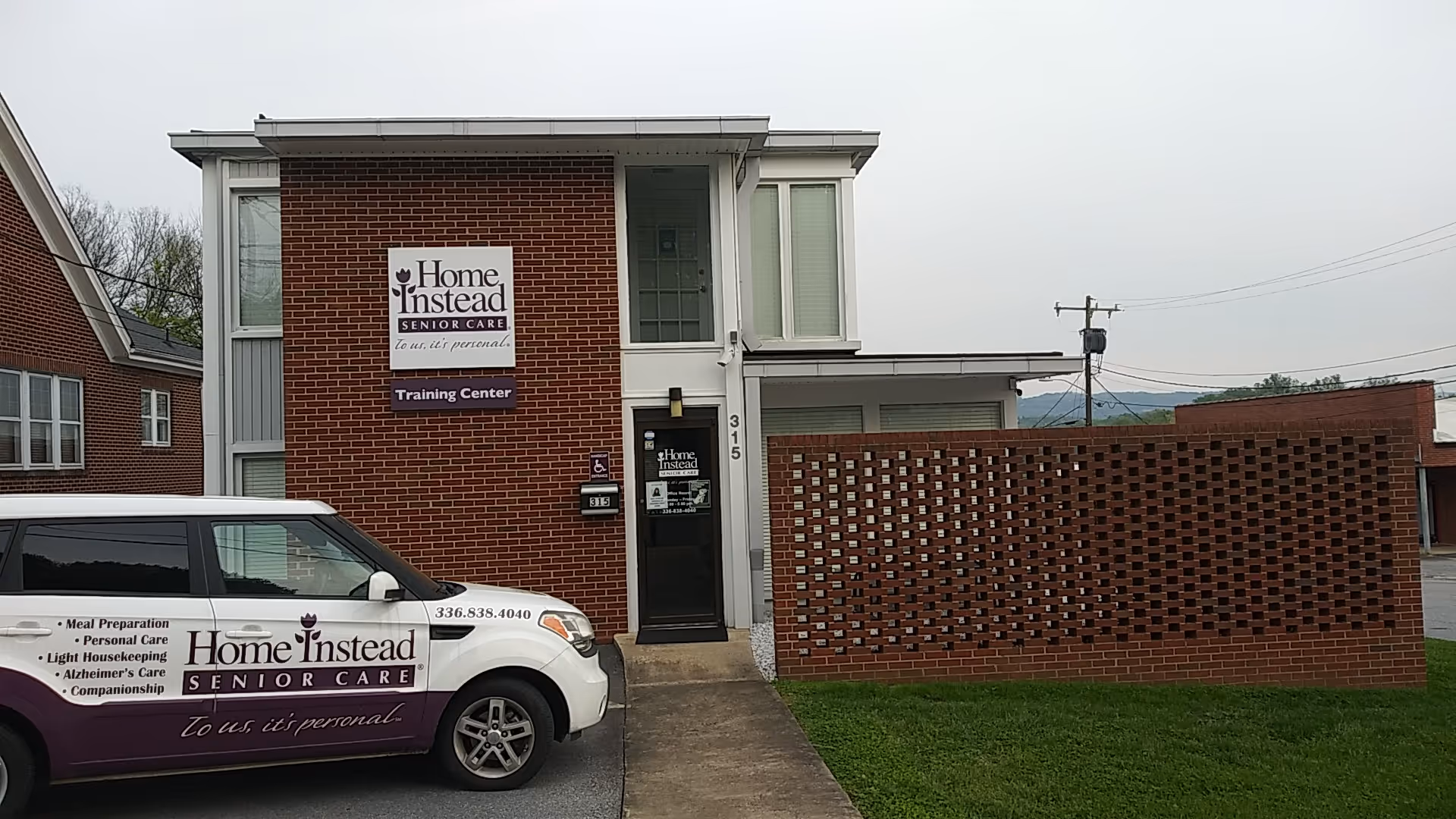 Exterior view of a Home Instead Senior Care building with a service van parked nearby.