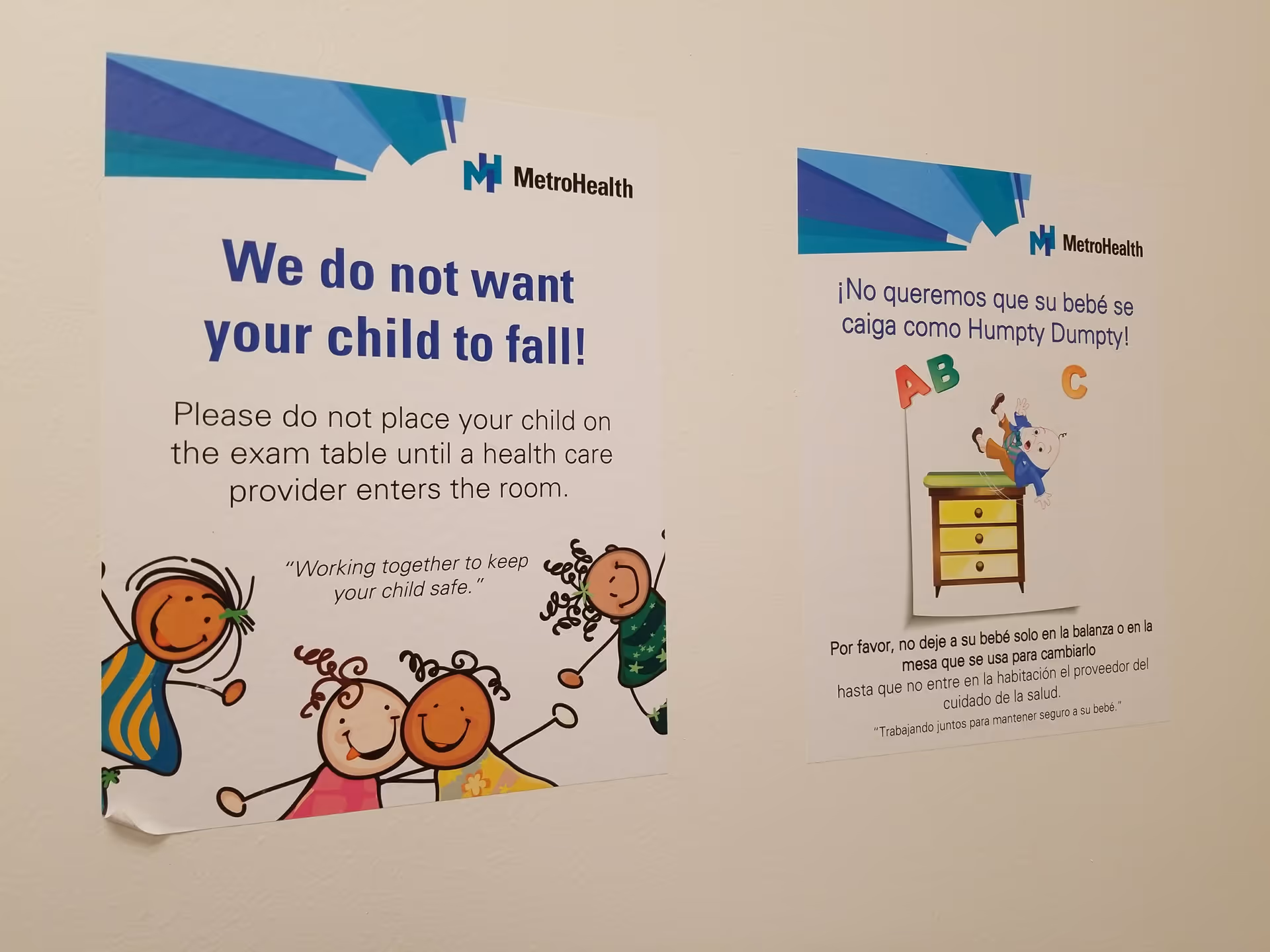 Two posters with safety messages and MetroHealth logos on a plain beige wall.