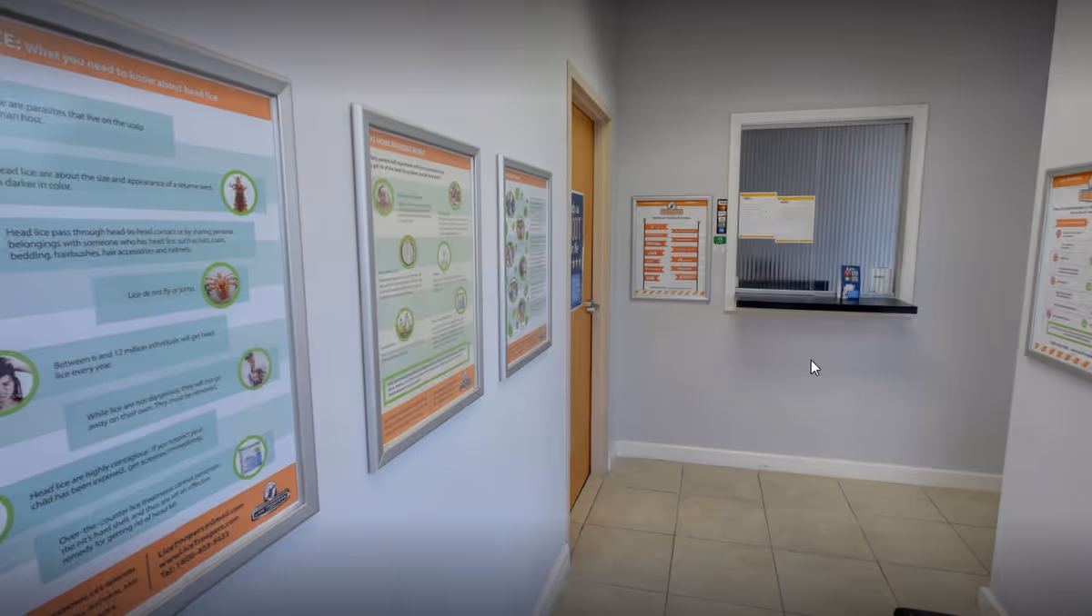 Interior hallway with framed posters and a service window.