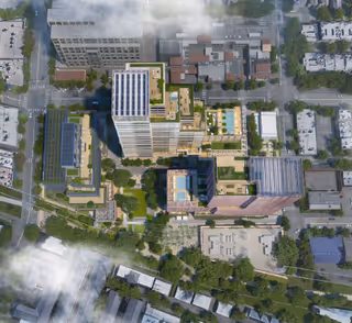 Aerial view of a multi-building senior living campus with green spaces and parking.