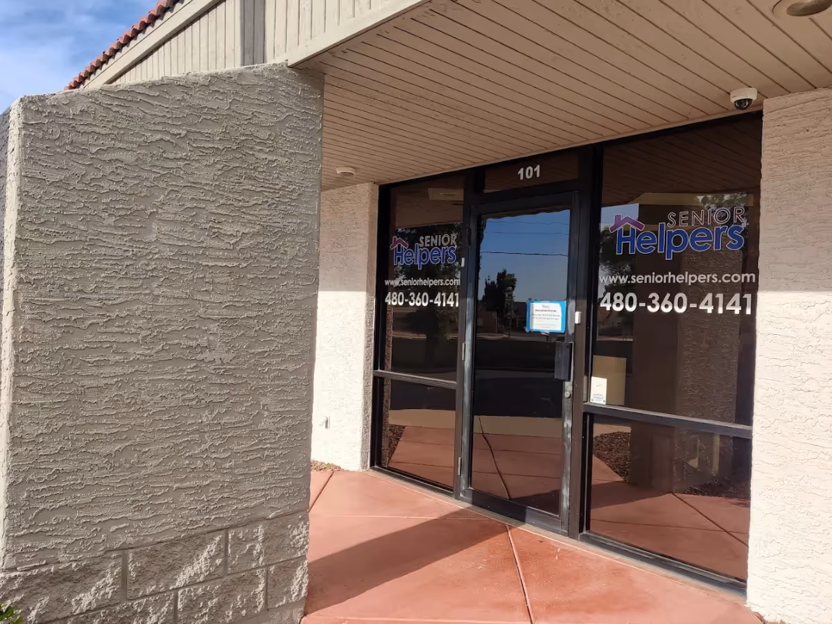 Exterior entrance of Senior Helpers facility with glass doors and the building number 101.