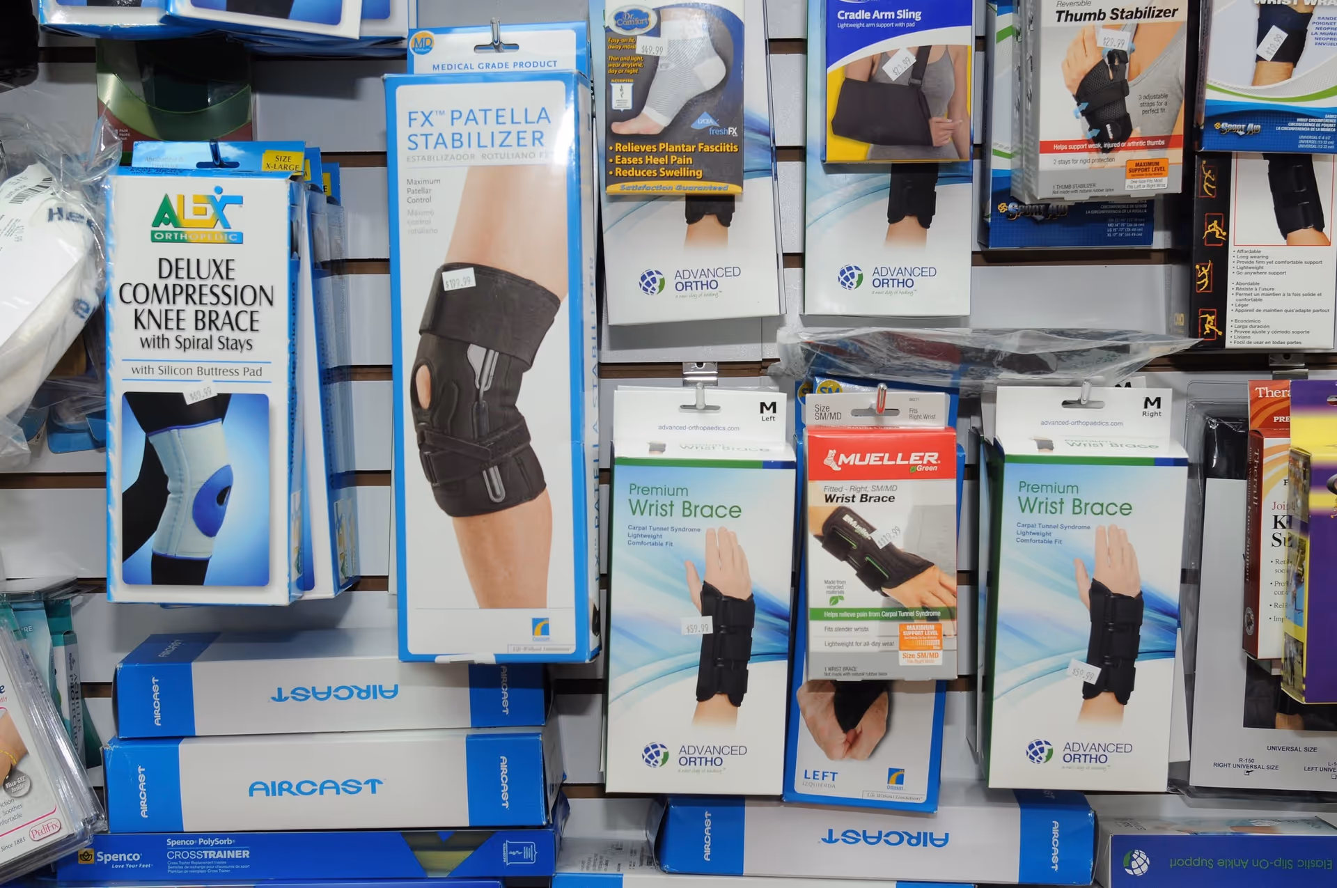 A wall of boxed medical braces and supports displayed on store shelves.