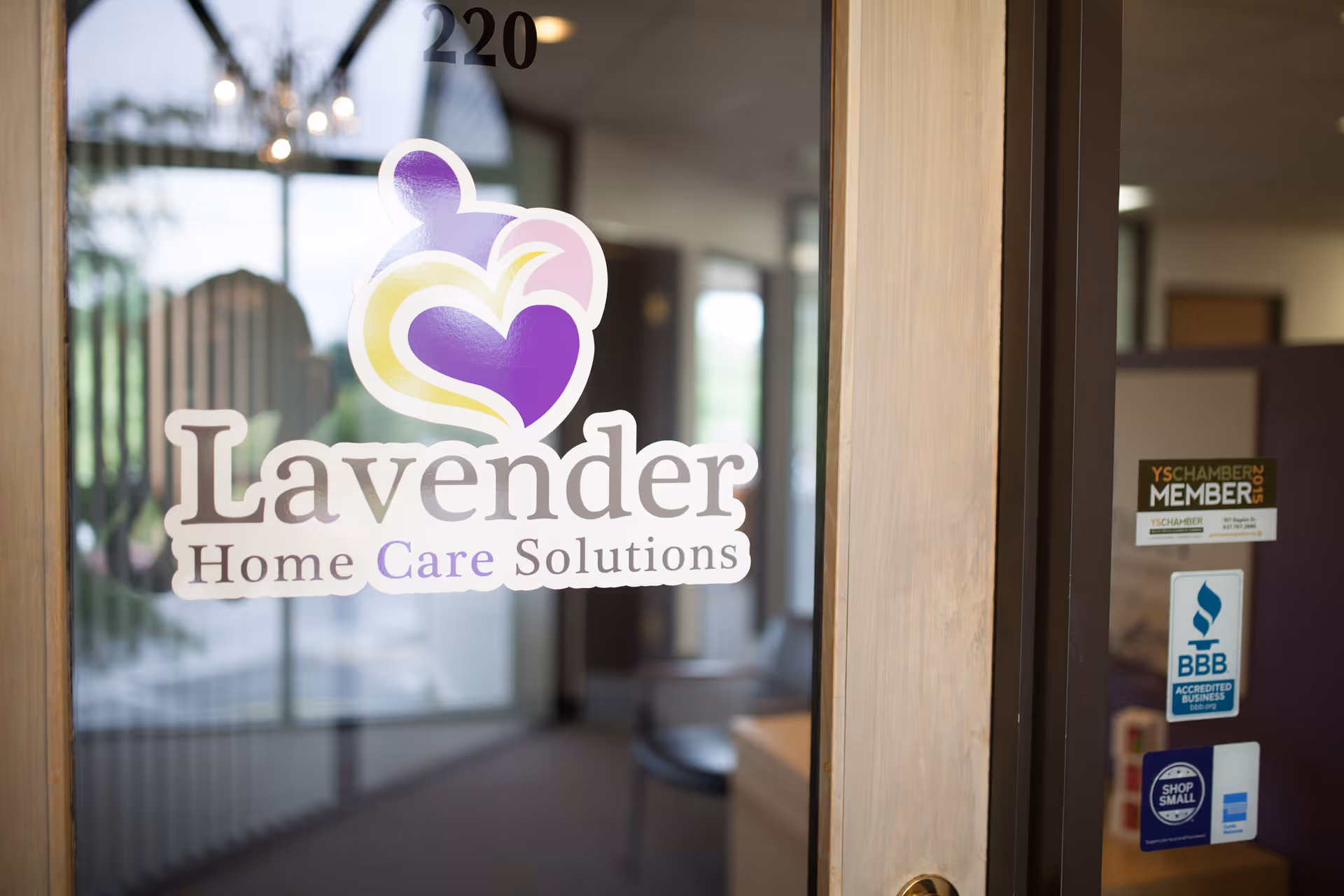 Glass entrance door shows Lavender Home Care Solutions logo; interior lobby and stickers visible.