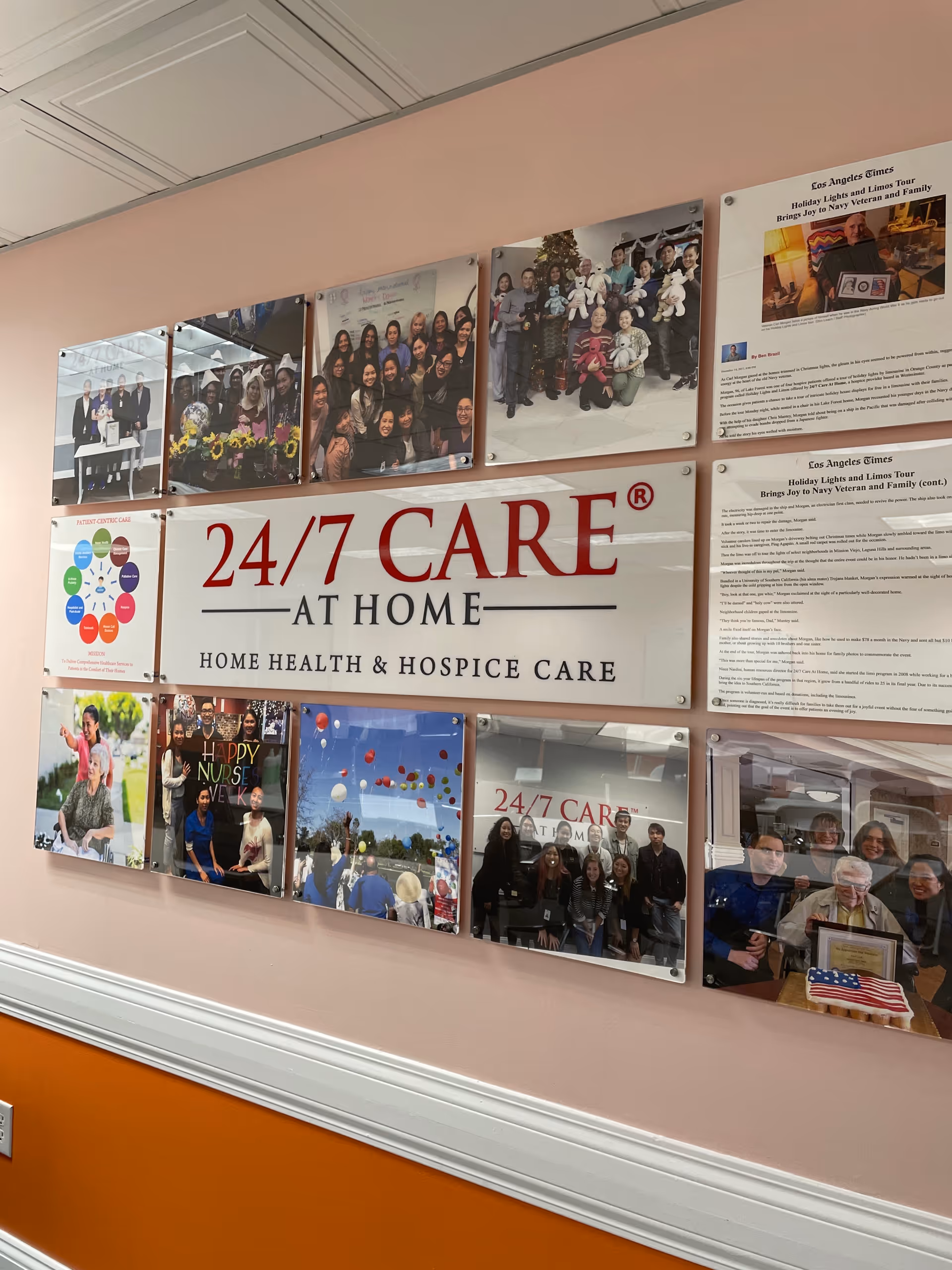 Interior wall with photo plaques surrounding a large 24/7 CARE AT HOME sign.