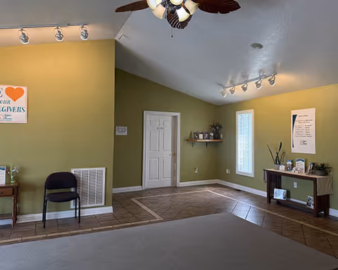 Interior common area with green walls, tiled floor, seating, and decor.