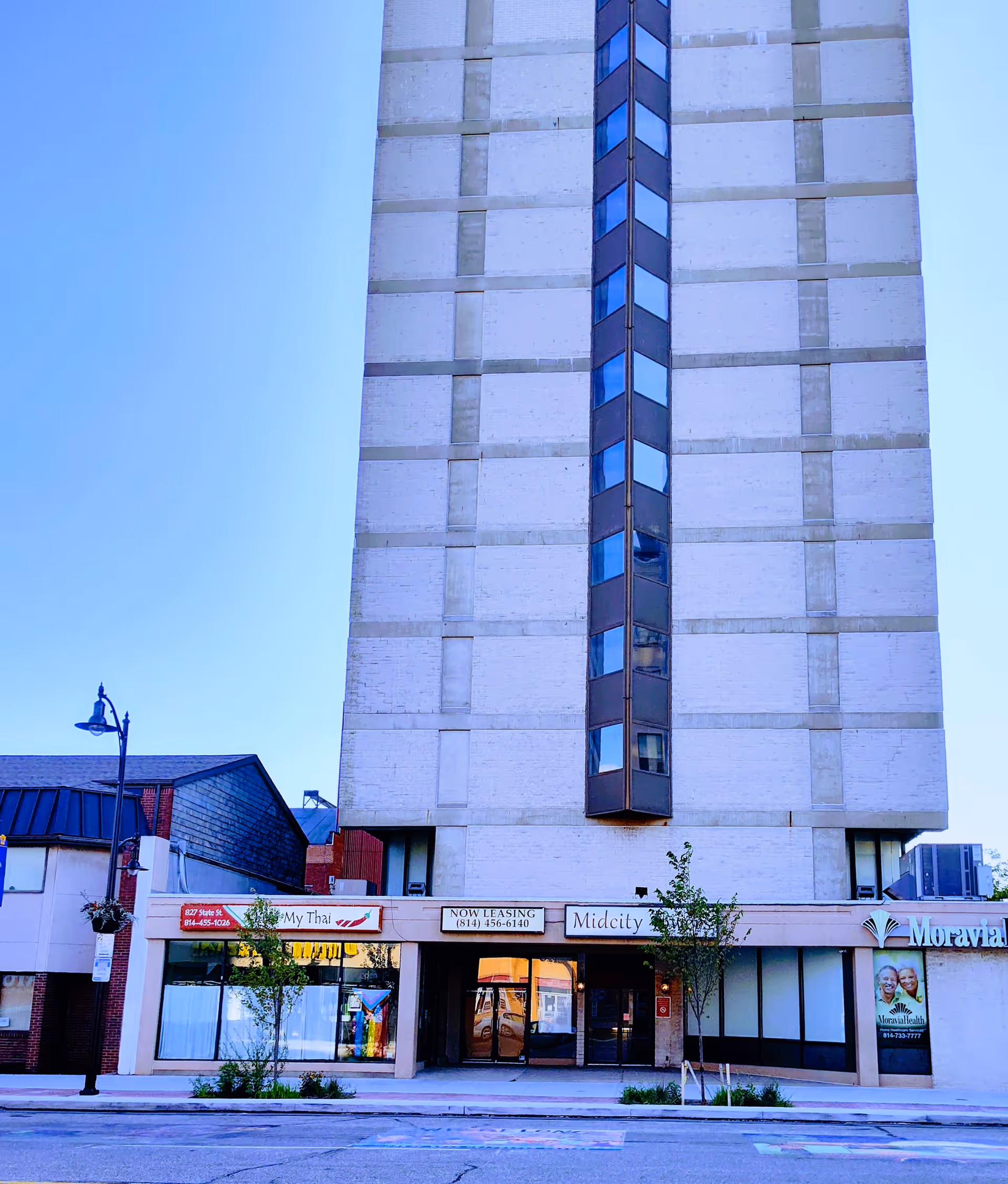 Tall, light-colored building with Moravia Health Erie storefronts at street level.