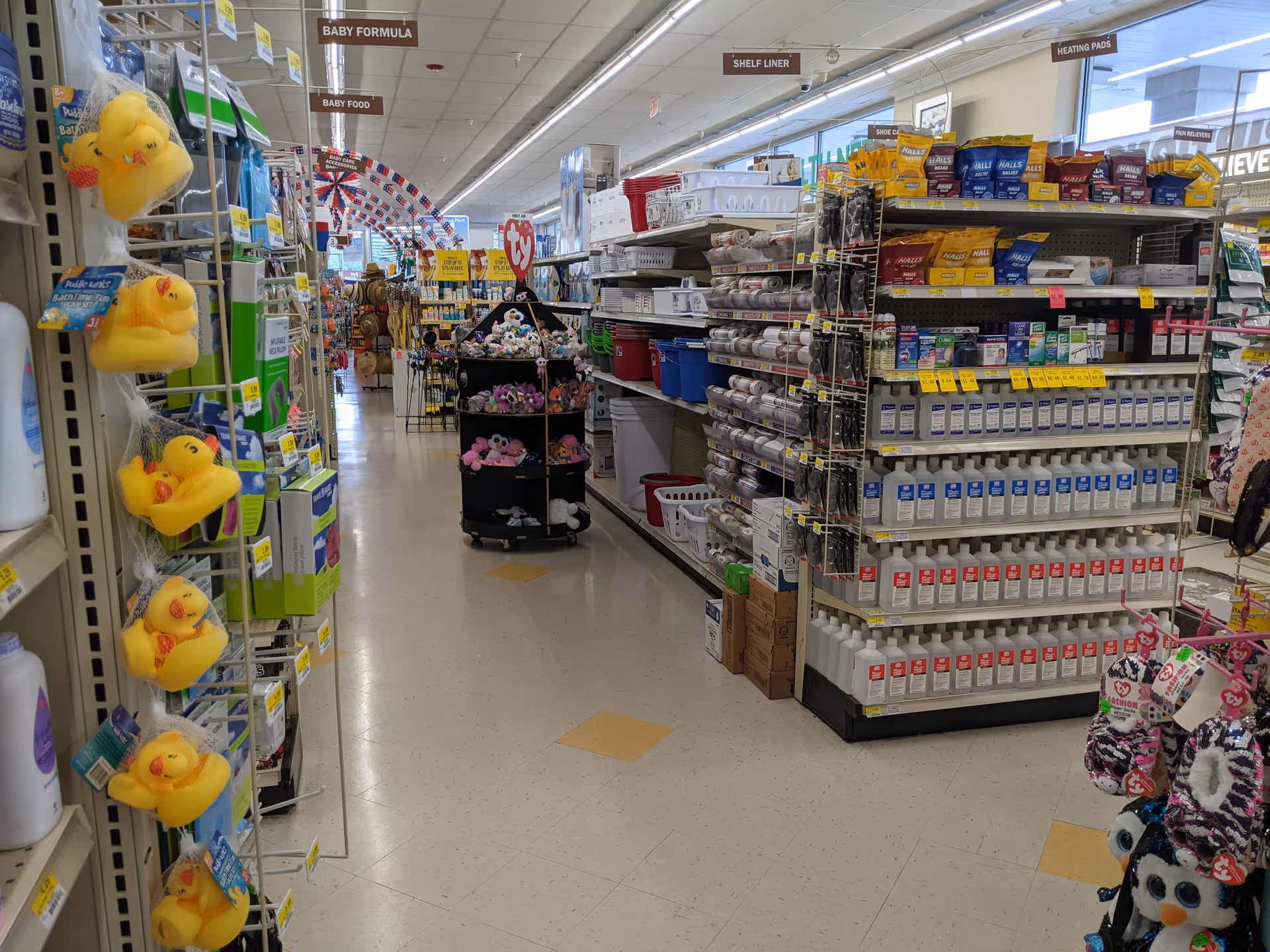 Aisle inside Discount Drug Mart with shelves of products and merchandise.
