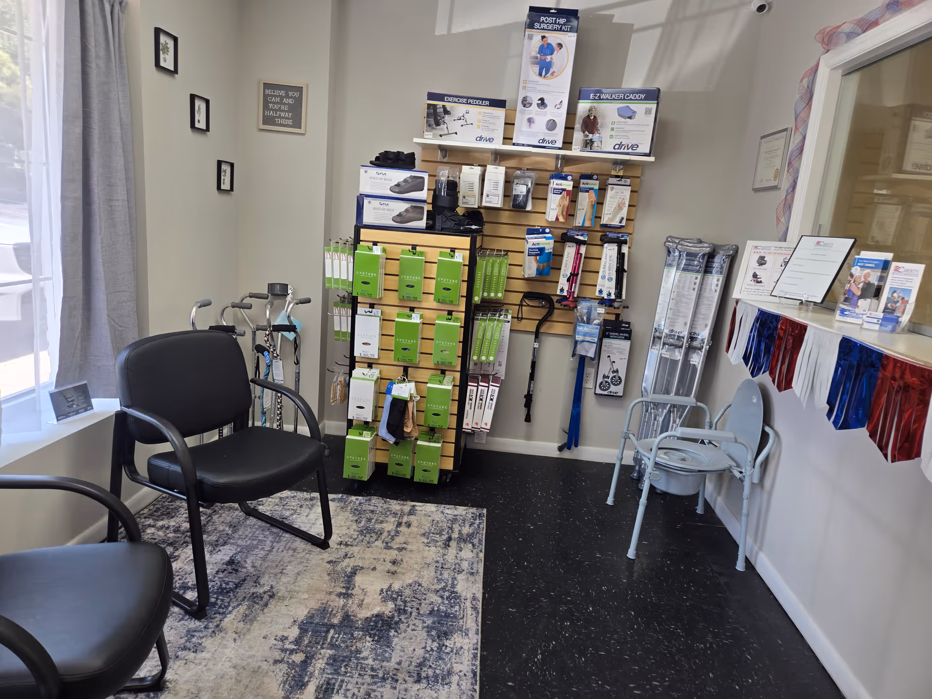 Interior patient reception area with chairs, a medical supply display, and walkers.
