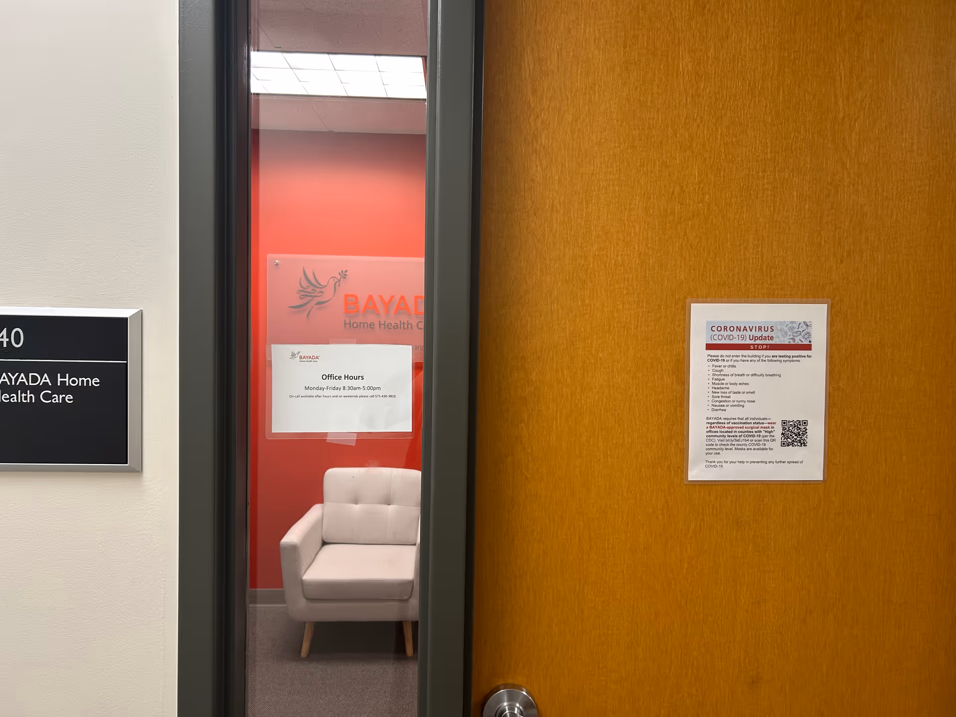 Interior doorway to BAYADA Home Health Care area with a beige chair and posted notices.