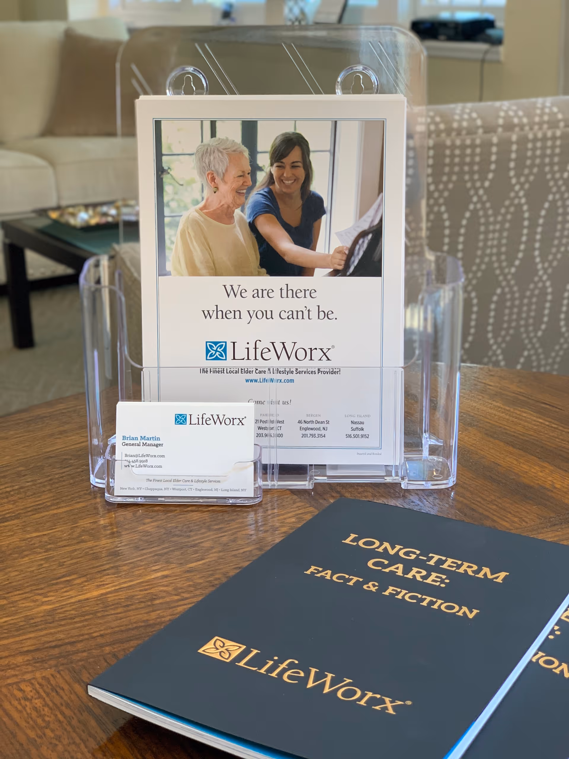 LifeWorx brochure, cards, and pamphlets on a wooden table in a bright living area.