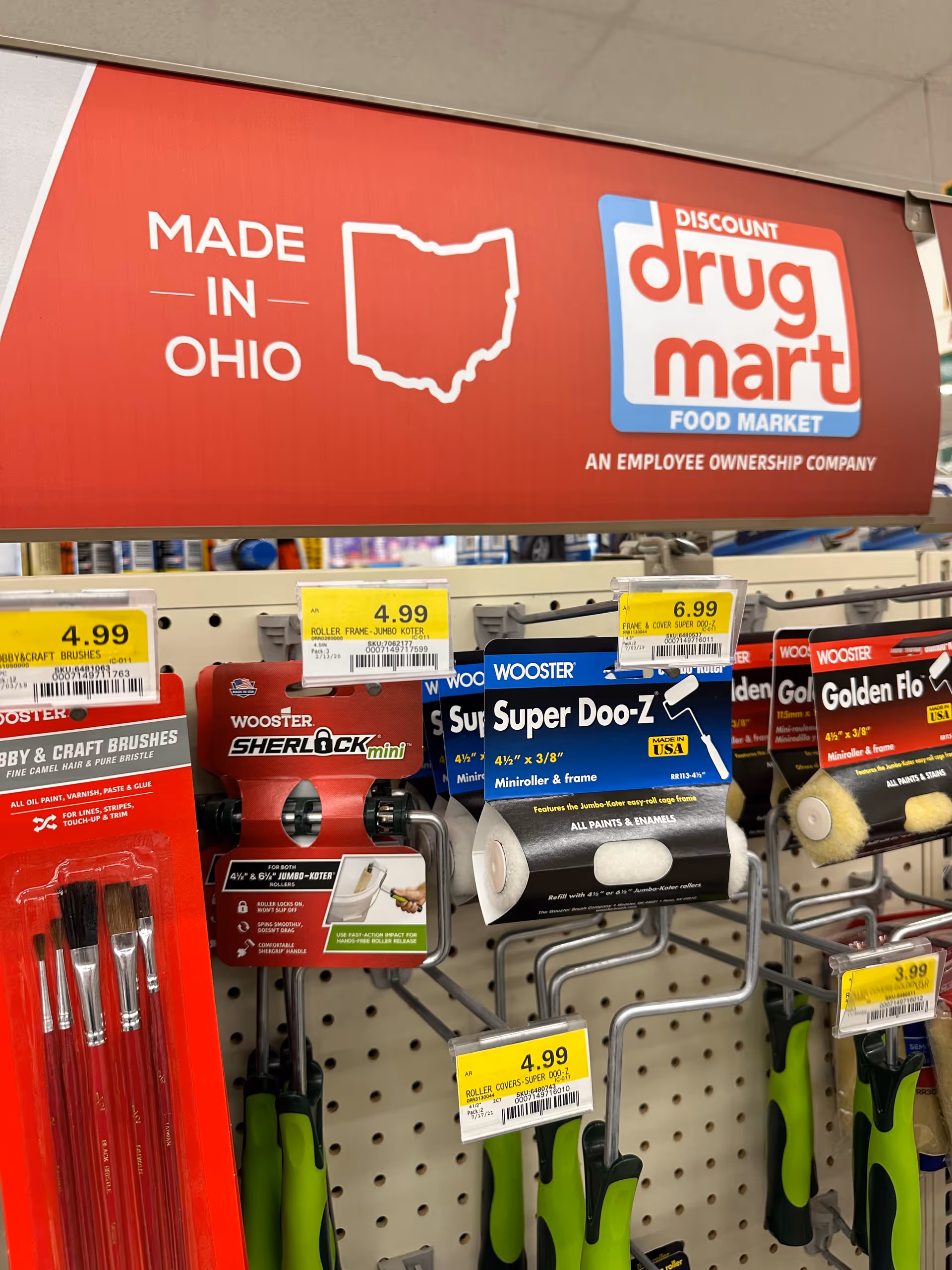 Red Discount Drug Mart banner above aisles of brushes and rollers.