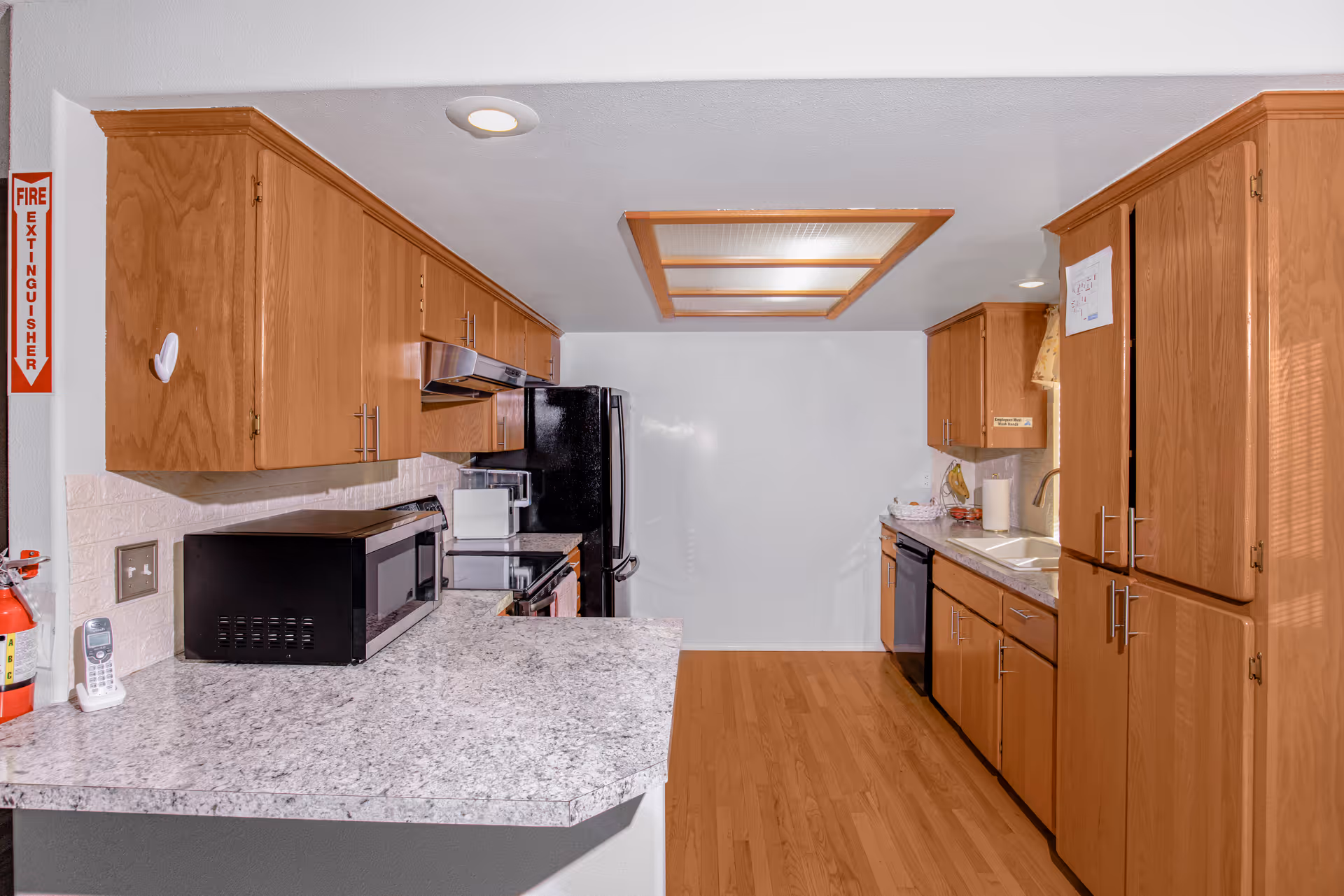 Kitchen of Clover Care Adult Family Home with wooden cabinets and modern appliances.