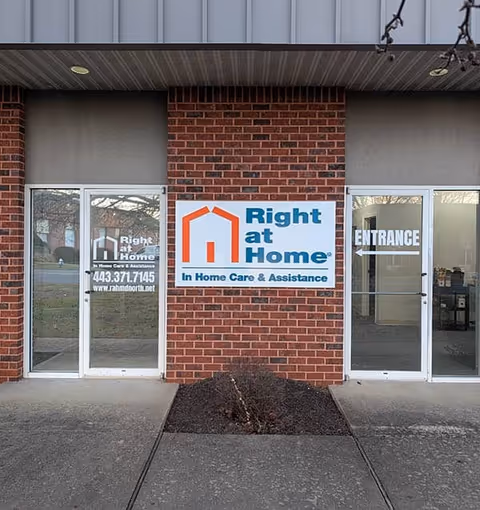Brick entrance with Right at Home sign and glass doors labeled Entrance.