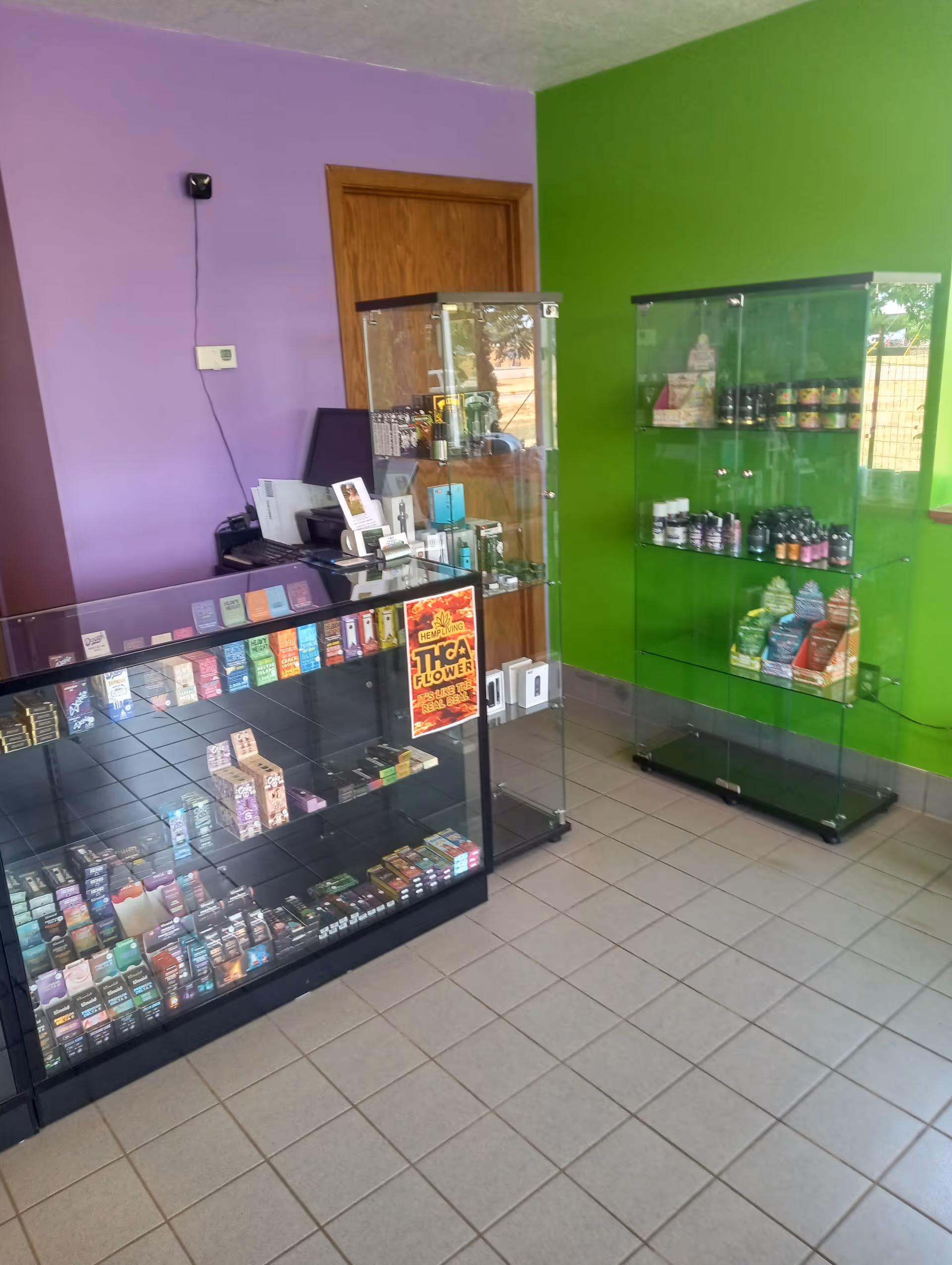 Inside a colorful senior living facility shop with glass display cases and assorted products.