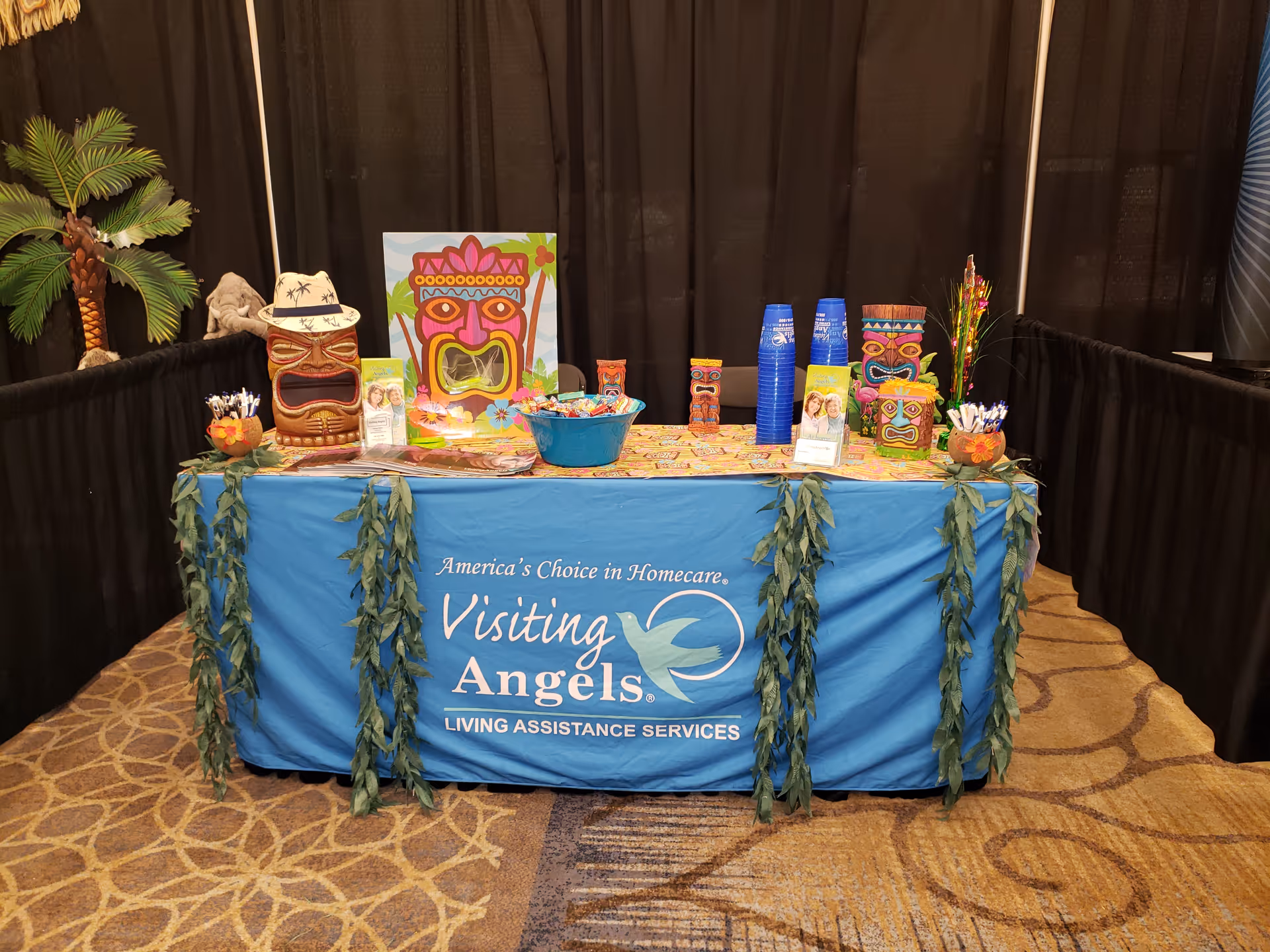 Exhibition booth for Visiting Angels Senior Home Care with a decorated table.