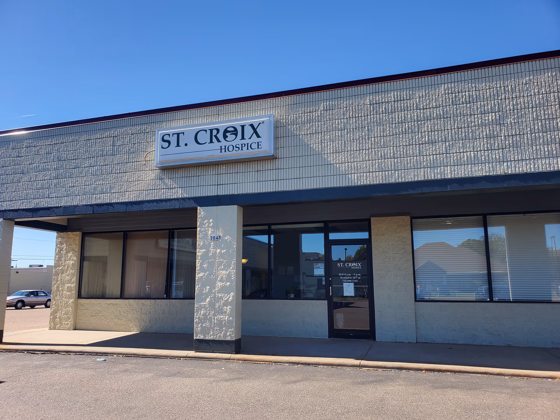 Front exterior of St. Croix Hospice building with sign and entrance