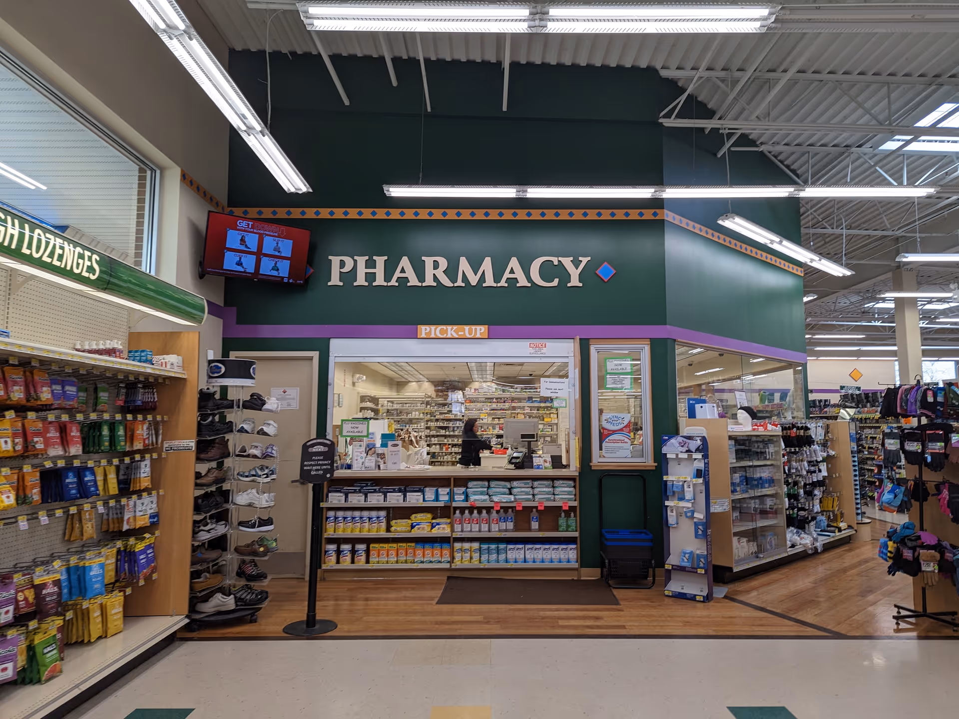 Interior view of a Discount Drug Mart pharmacy with shelves, counter, and products.